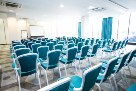 Tower Room at Hilton London Olympia: teal chairs for conferences and workshops.