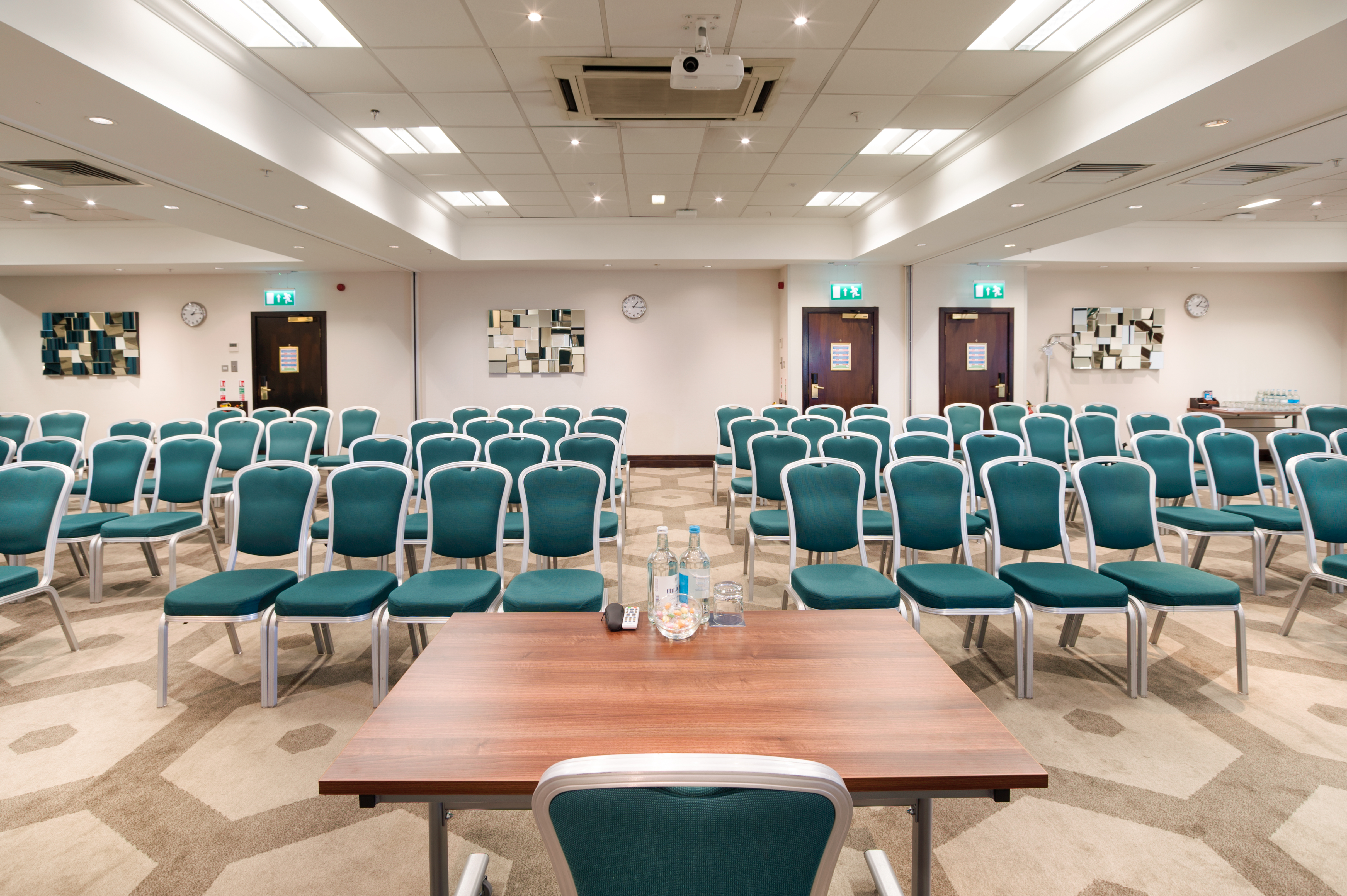 Pembroke Suite at Hilton London Olympia, teal chairs for corporate meetings and workshops.