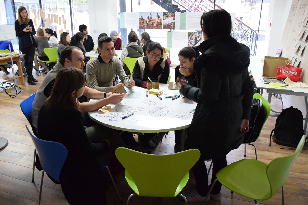 "Collaborative meeting at OXO Tower with diverse participants brainstorming ideas."