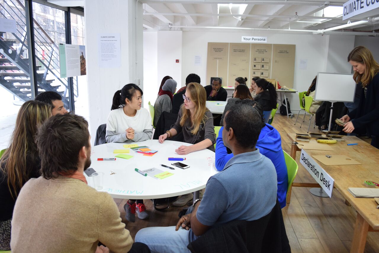 Collaborative workshop at OXO Tower with diverse participants and round table setup.