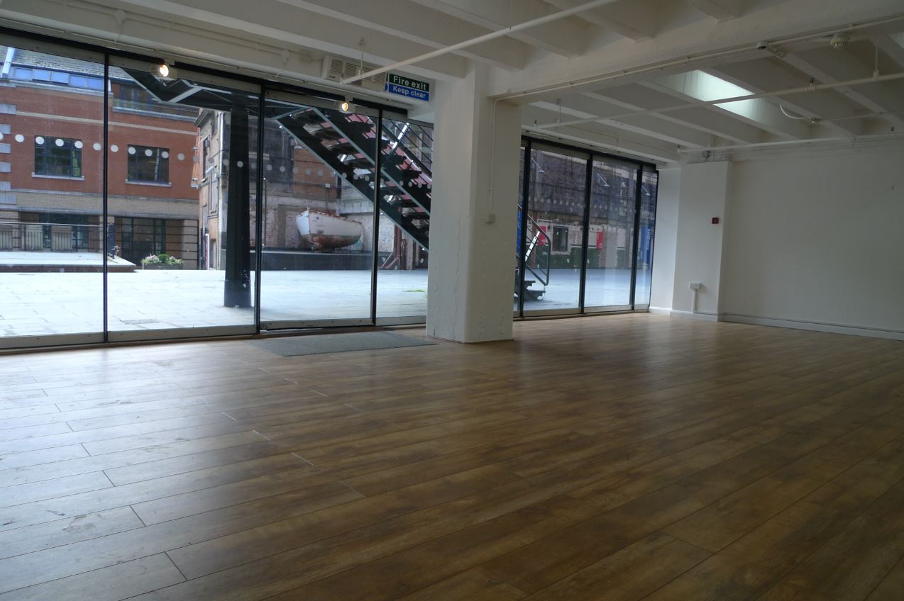 Spacious G11 event space in OXO Tower with large windows and polished wooden floor.