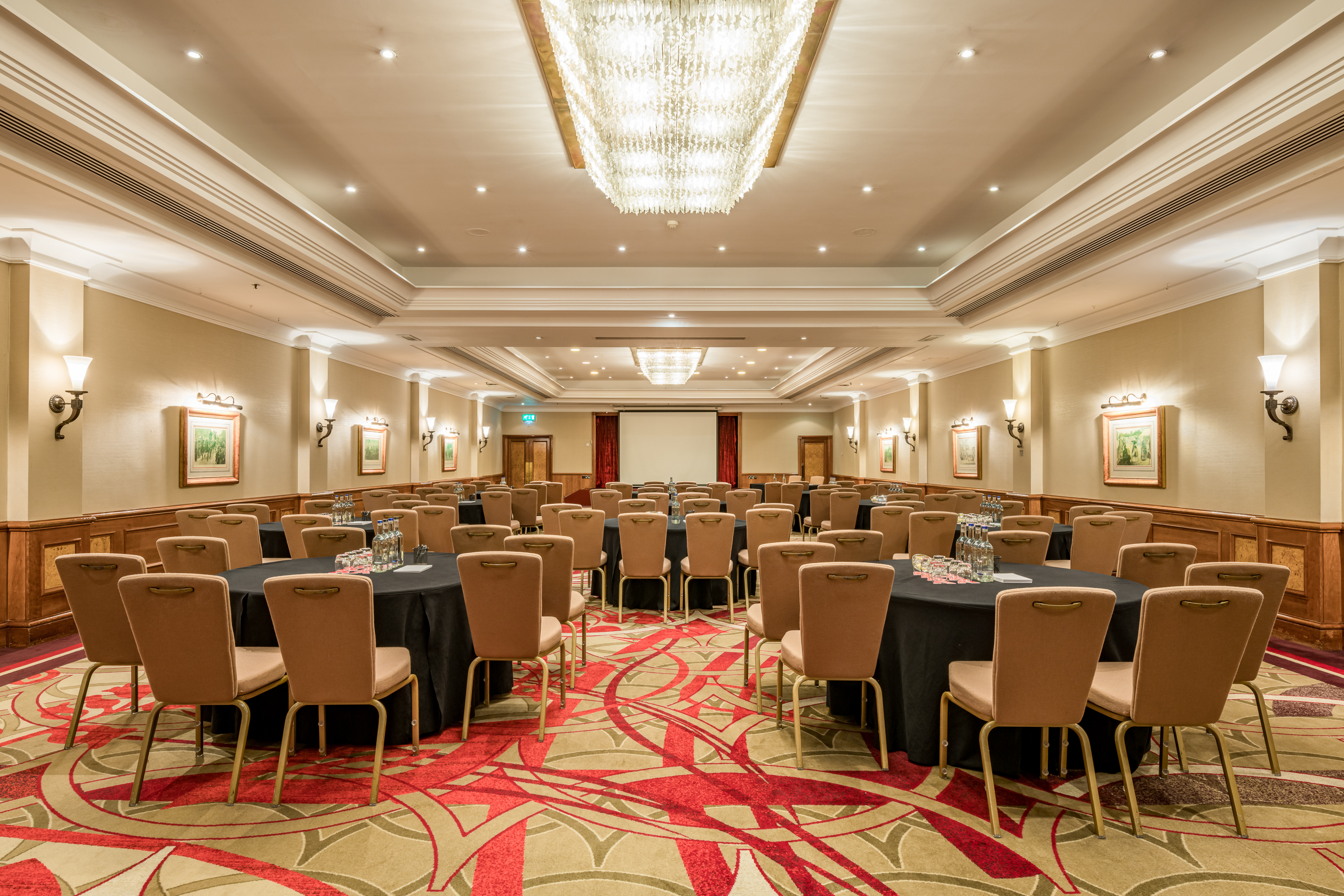 Elegant meeting space with round tables, ideal for networking events and presentations.