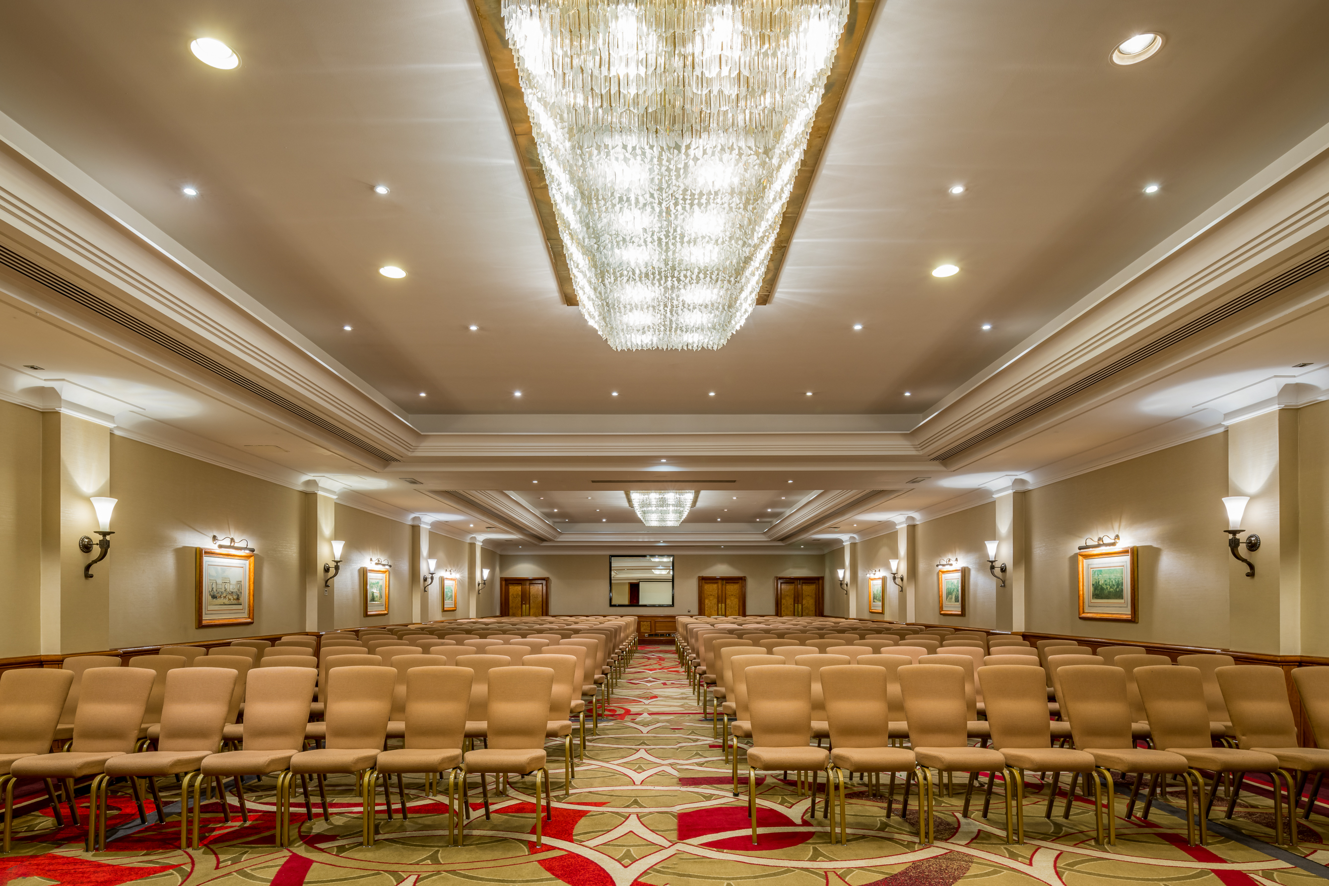 Conference room at Thistle Marble Arch with beige chairs, ideal for seminars and presentations.