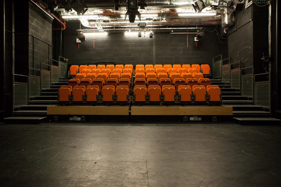 New Diorama Theatre with vibrant orange tiered seating, ideal for performances and workshops.