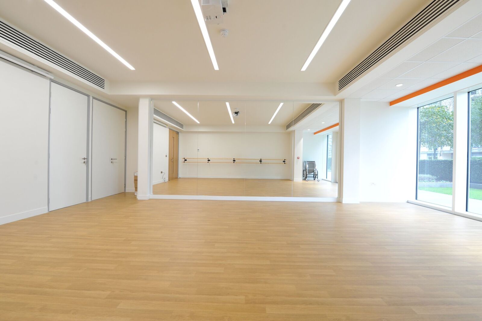 Muir-Warden Studio: bright event space with large mirror for workshops and fitness classes.