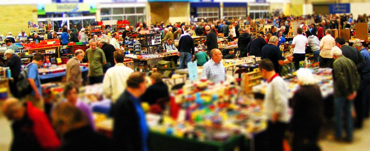 Showering Pavilion at a bustling trade show with diverse attendees and vendor booths.