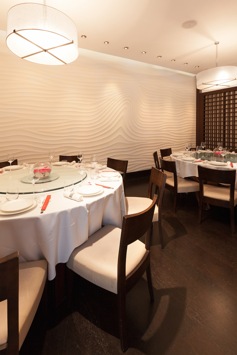 Private dining room with round table, ideal for intimate meetings and events.