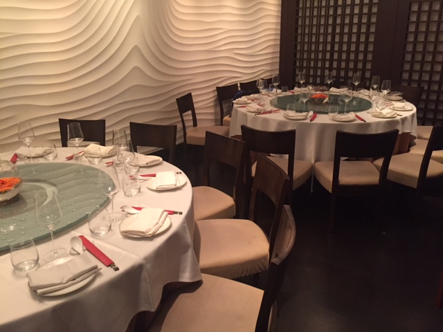 Elegant private dining room with round tables for upscale events and corporate dinners.