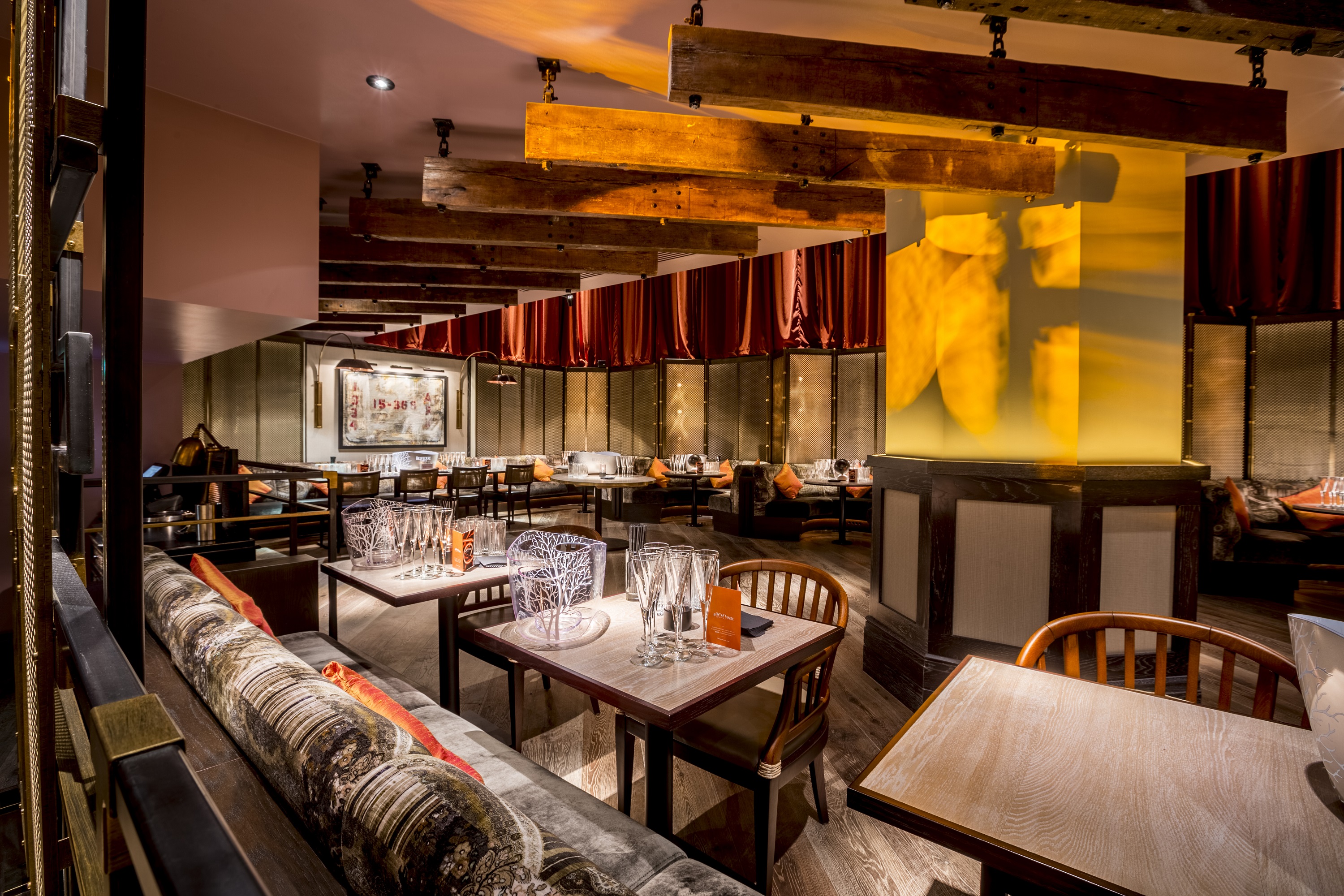 Stylish restaurant interior with wooden beams, ideal for networking events and private dinners.