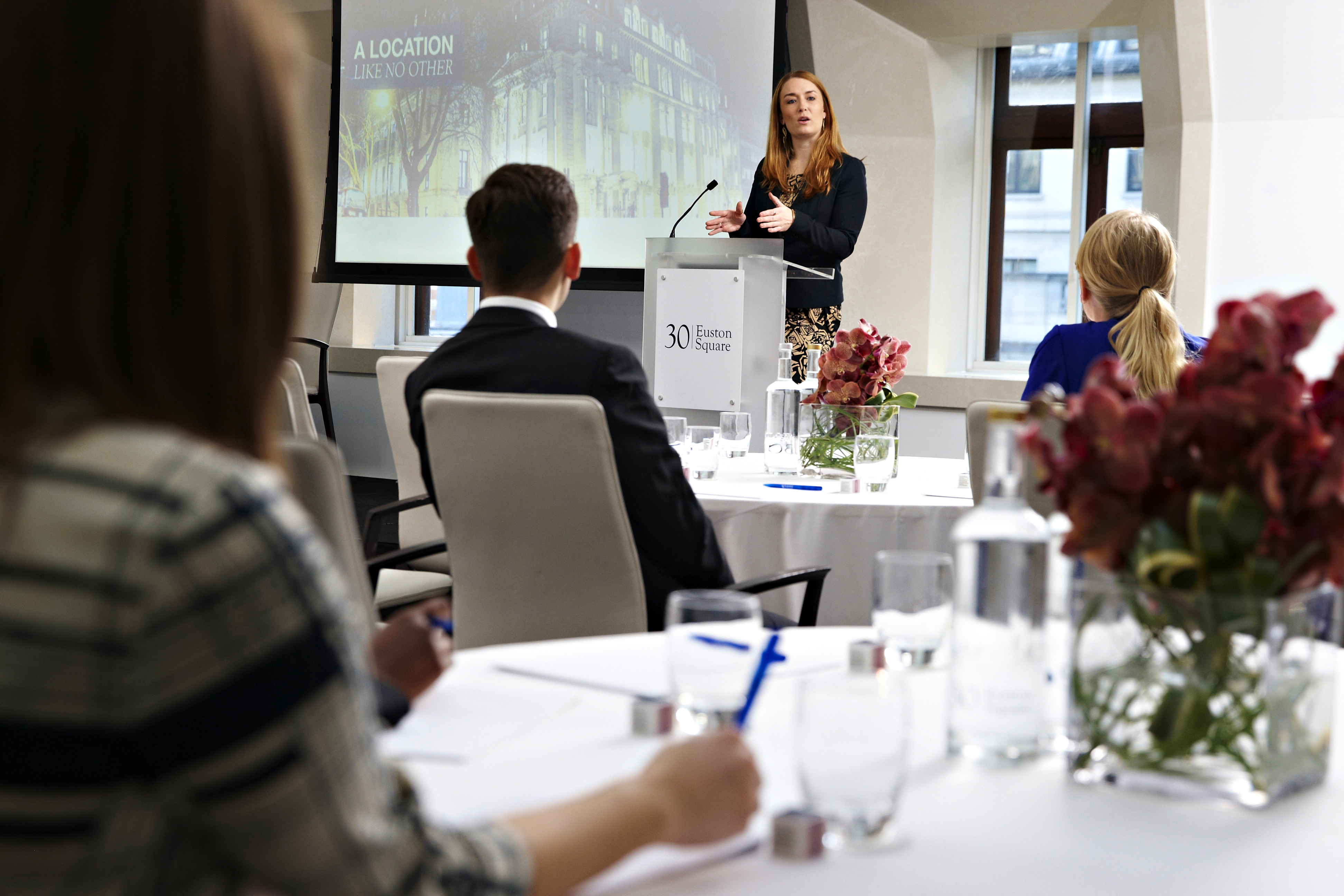 Professional meeting in modern conference room at 30 Euston Square, engaging speaker.