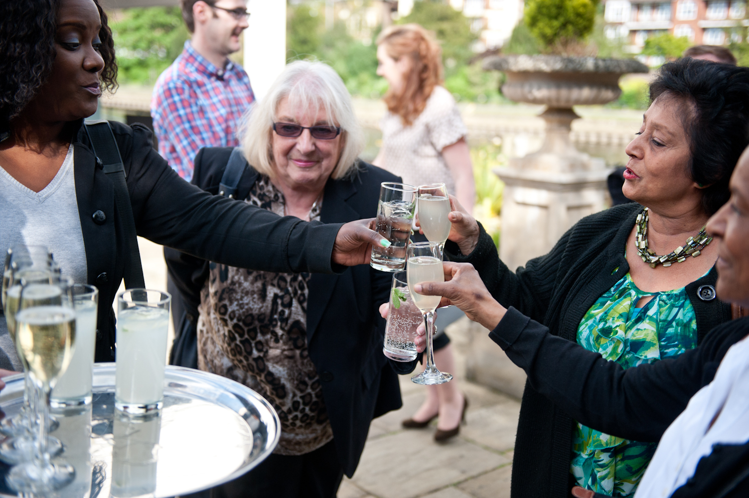 Lively networking event on Ravens Ait Island with attendees toasting outdoors.