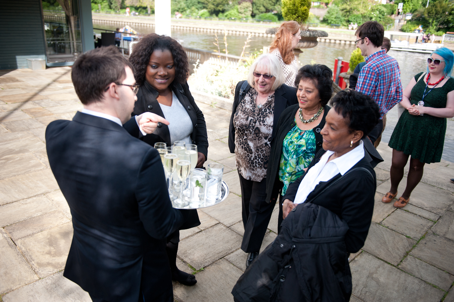 Outdoor networking event at Ravens Ait Island with guests in formal attire.