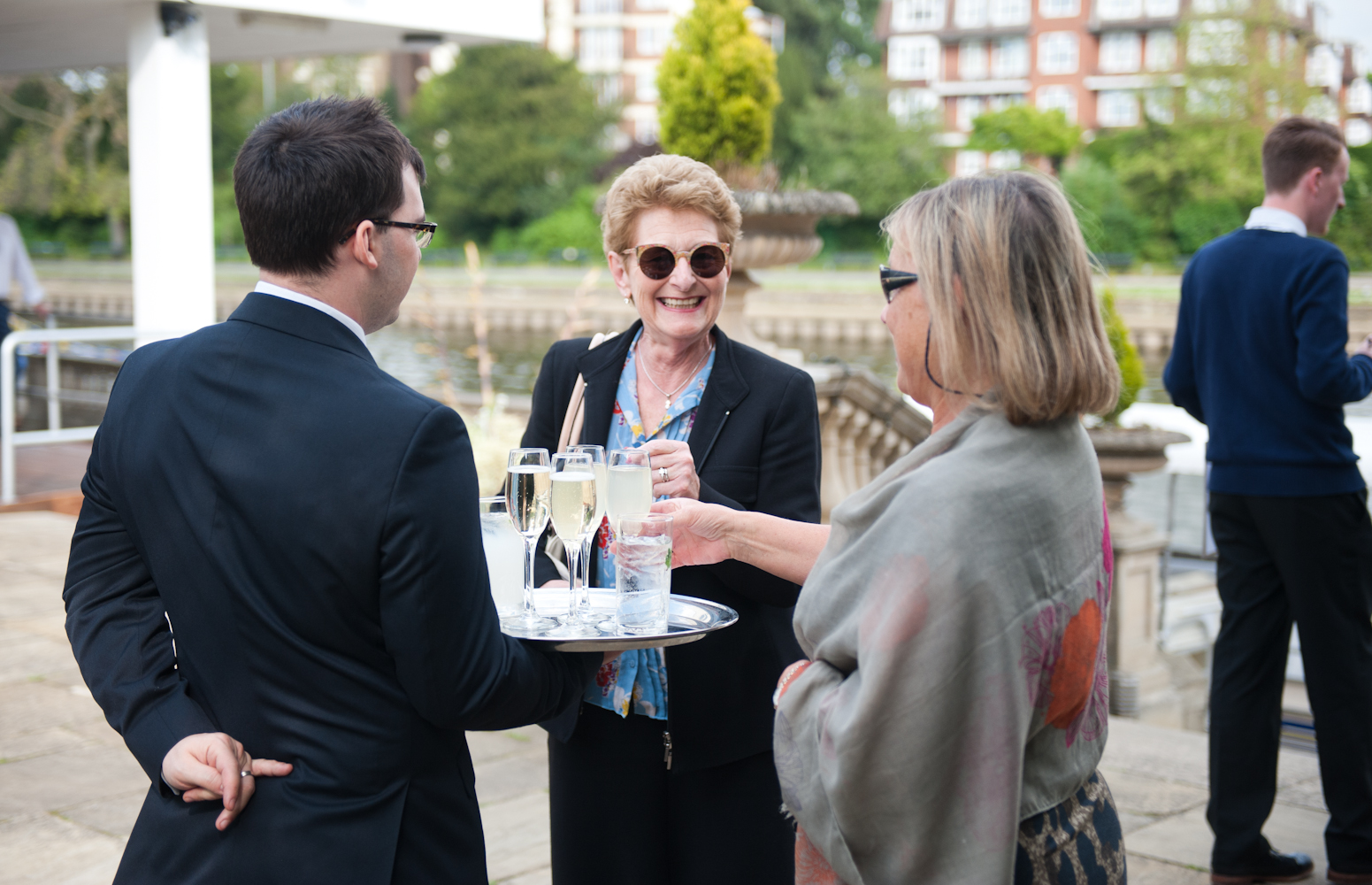 Outdoor reception at Ravens Ait Island with guests networking and enjoying drinks.