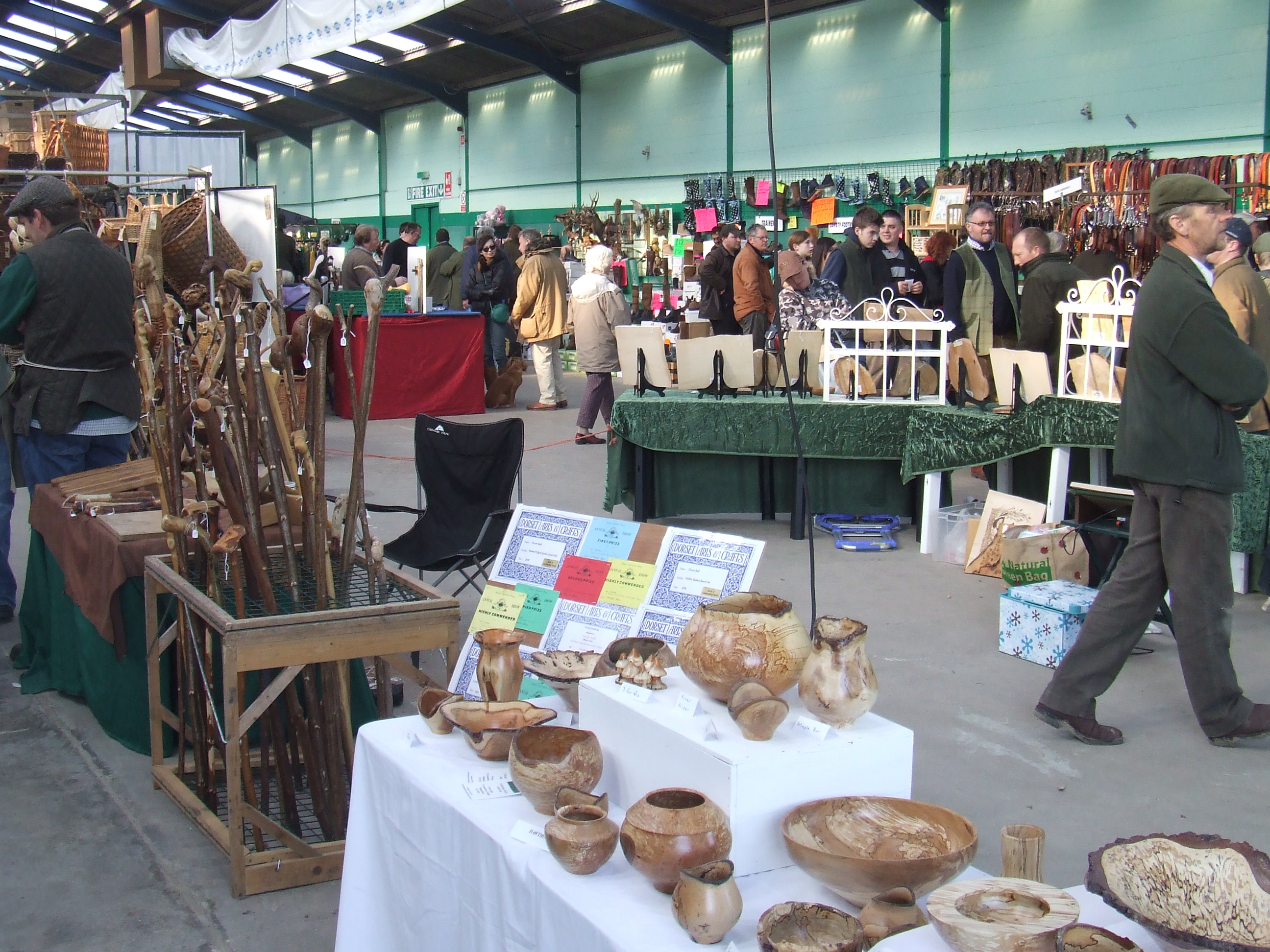 Indoor market at Bath & West Showground showcasing local artisans and community engagement.