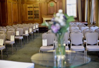 Churchill Room at Goodenough House, elegant meeting space with floral centerpiece.