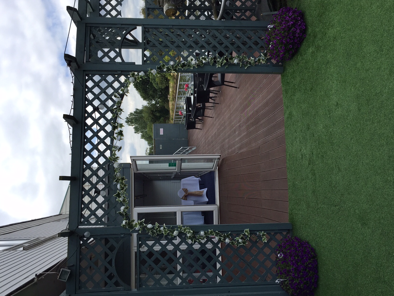 Thames Suite outdoor event space with greenery archway, ideal for receptions and gatherings.