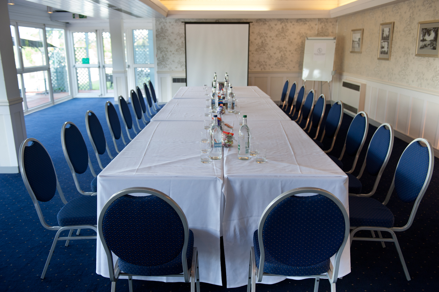 Thames Suite meeting room with blue chairs, ideal for professional gatherings and presentations.