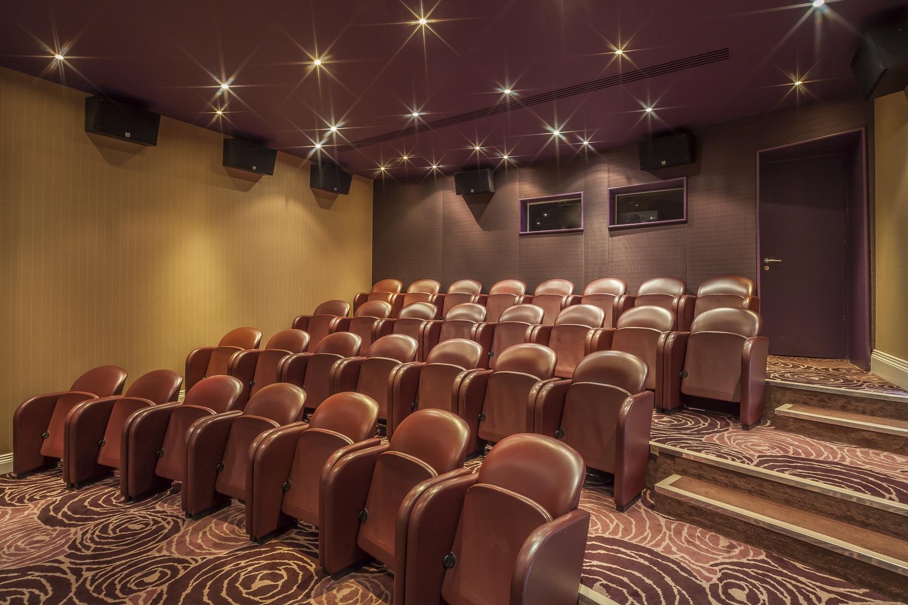 Cozy Upstage Mini Cinema with plush seating for private film screenings and events.