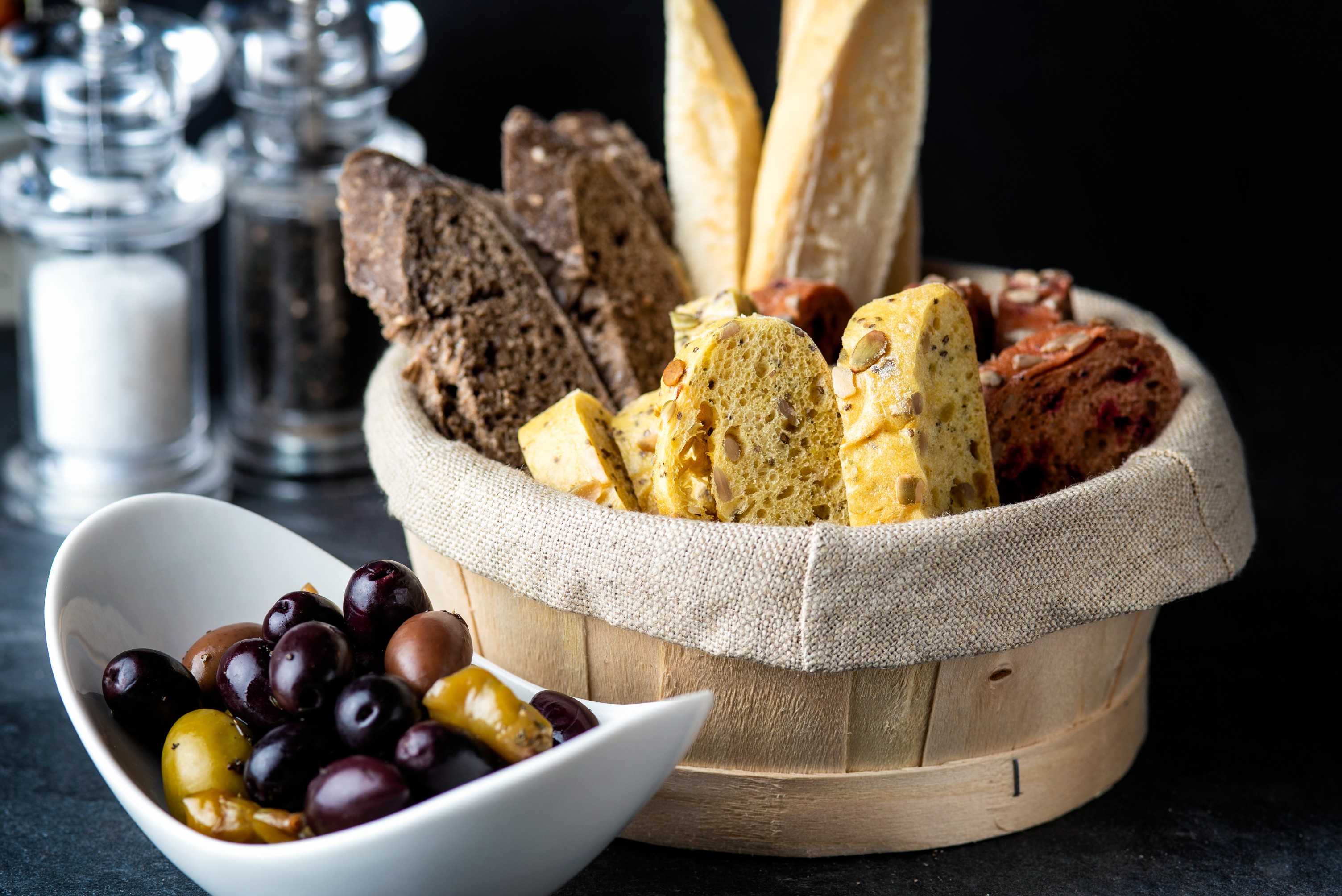 Artisanal bread basket and olives at TwoRuba Bar, Hilton London Tower Bridge event dining.