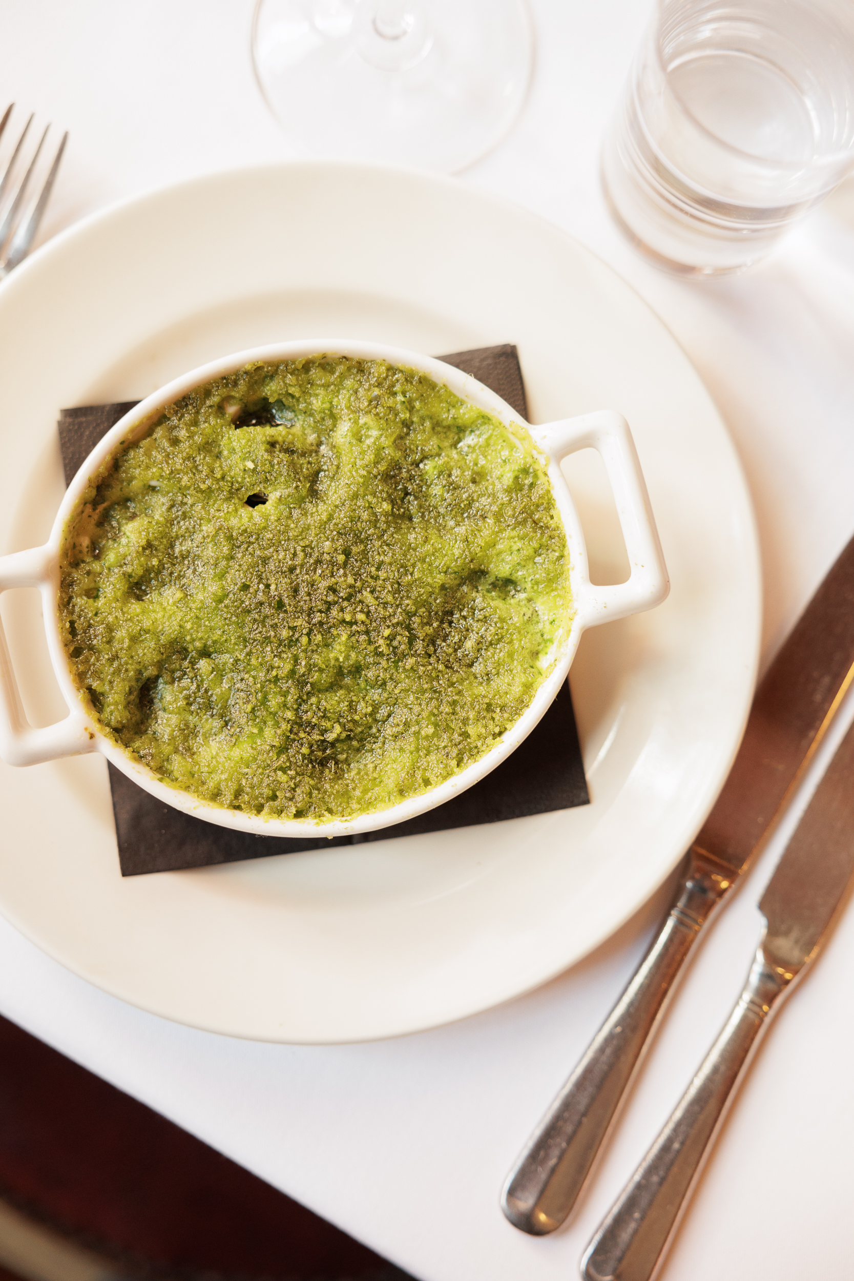 Upscale green herb gratin dish for gourmet dinner catering events.