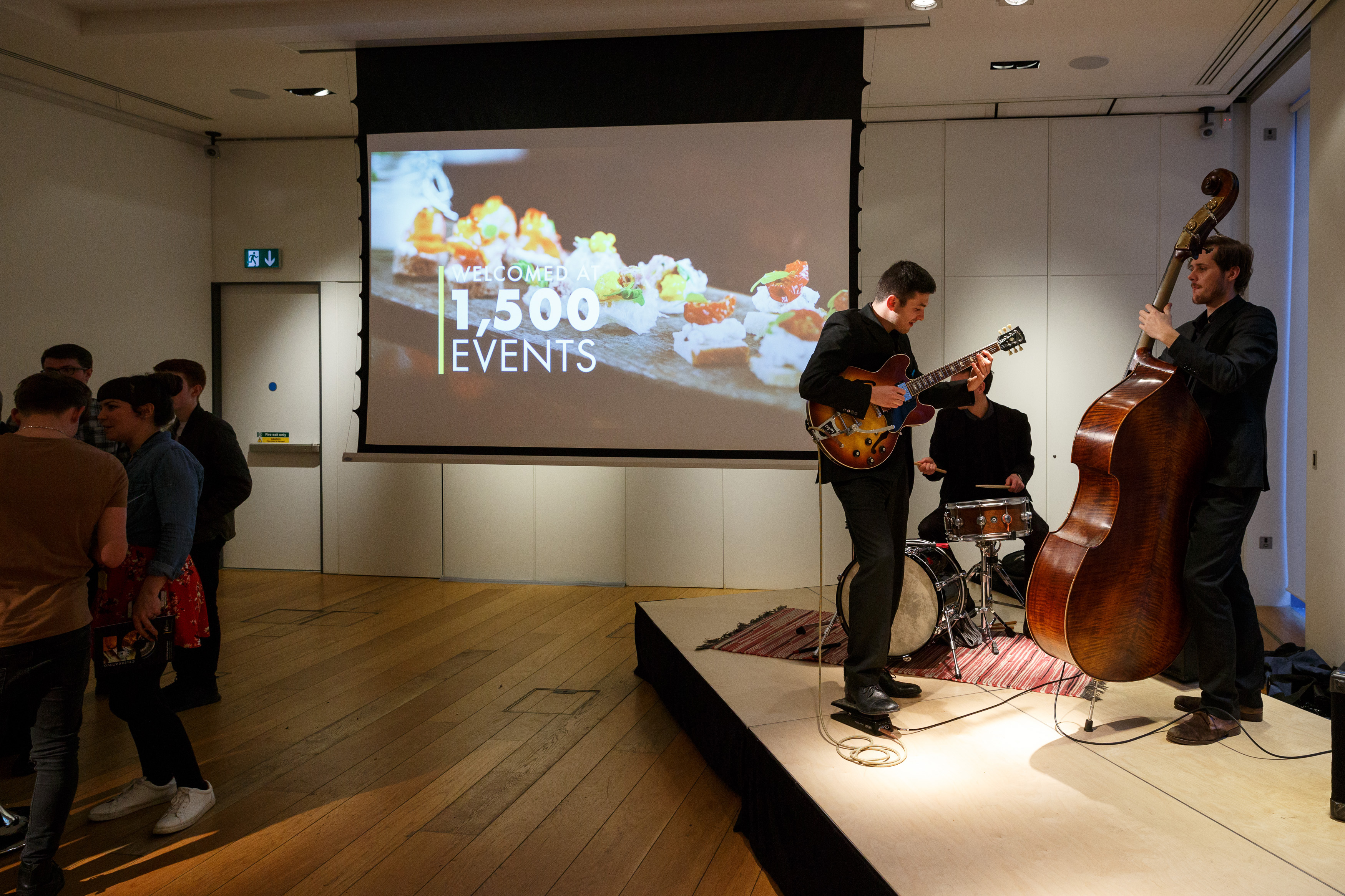 Vibrant exhibition room with live music for engaging networking events at The Goldsmiths' Centre.
