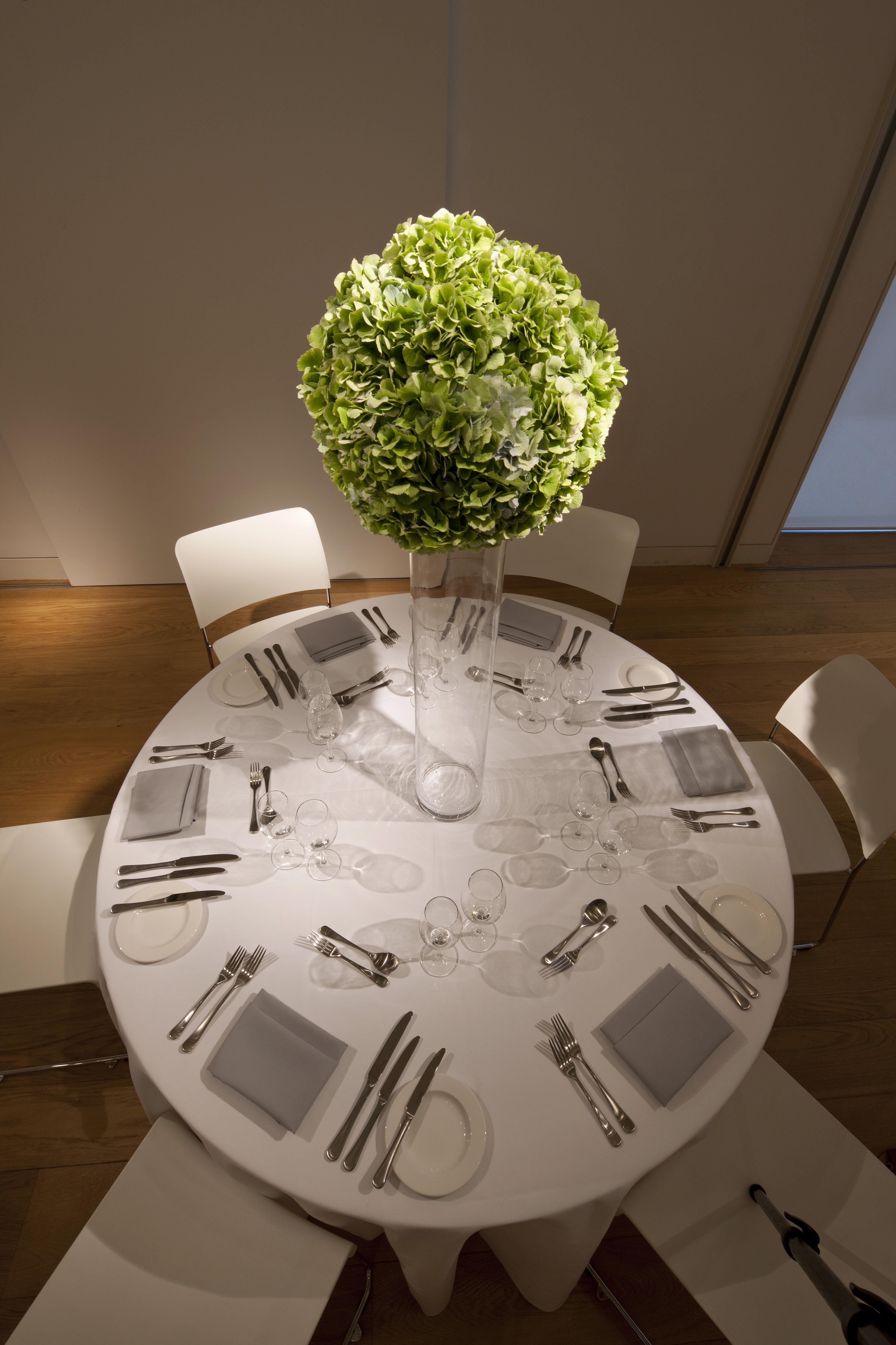 Elegant round table with floral centerpiece for upscale dinner events at The Goldsmiths' Centre.