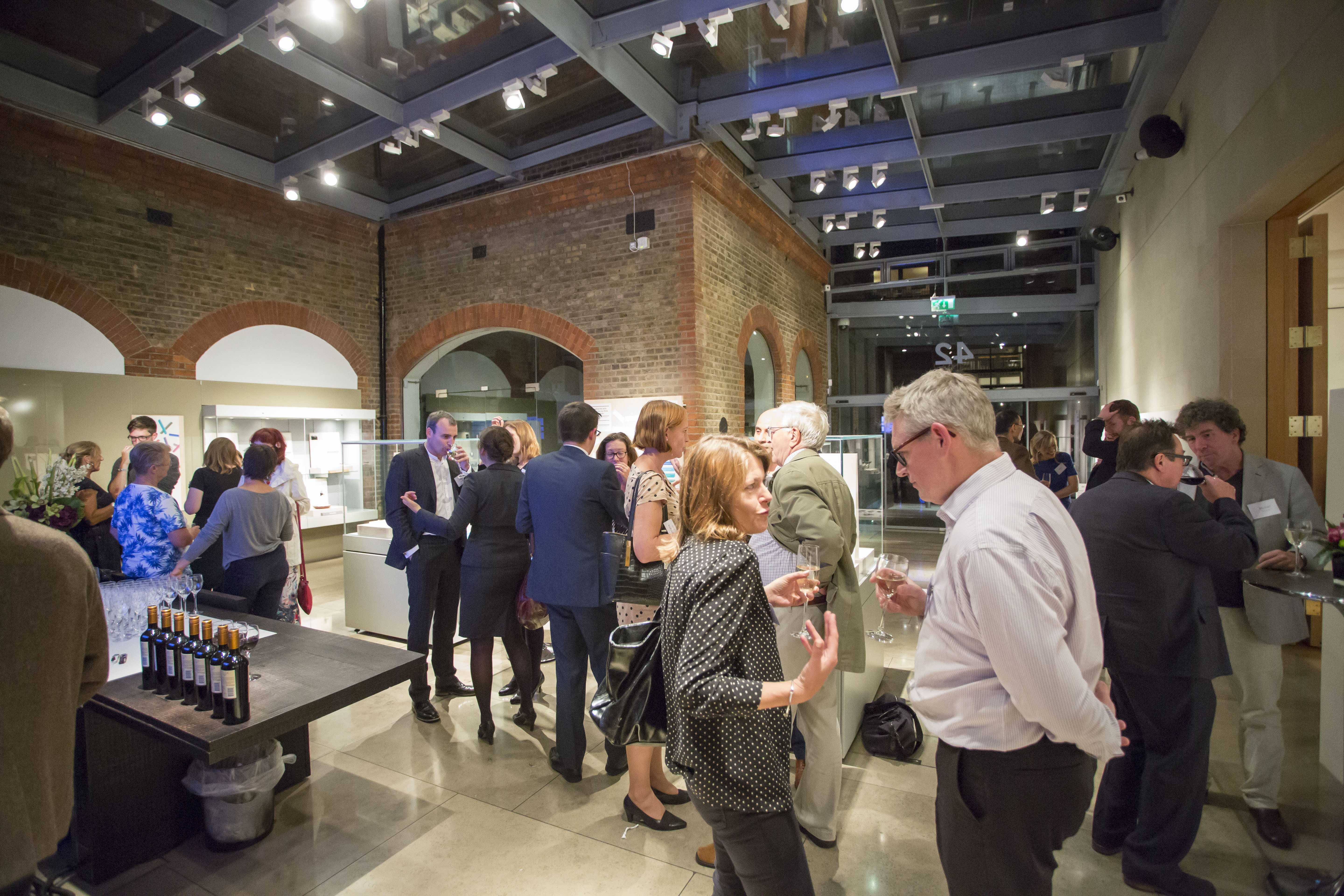 Vibrant networking event in The Goldsmiths' Centre Atrium with modern architecture.