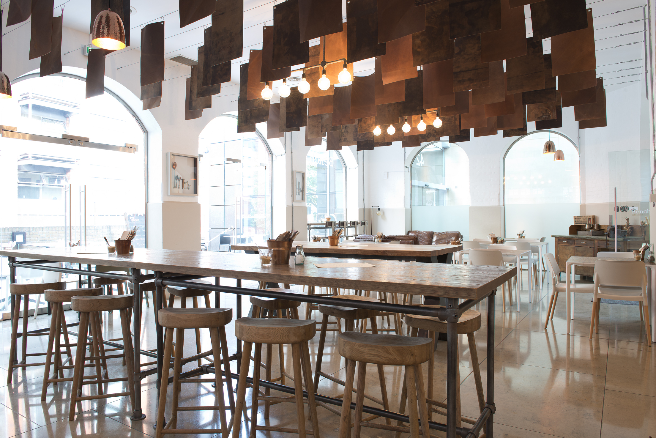 Modern event space with communal table, ideal for meetings and networking at Goldsmiths' Centre.