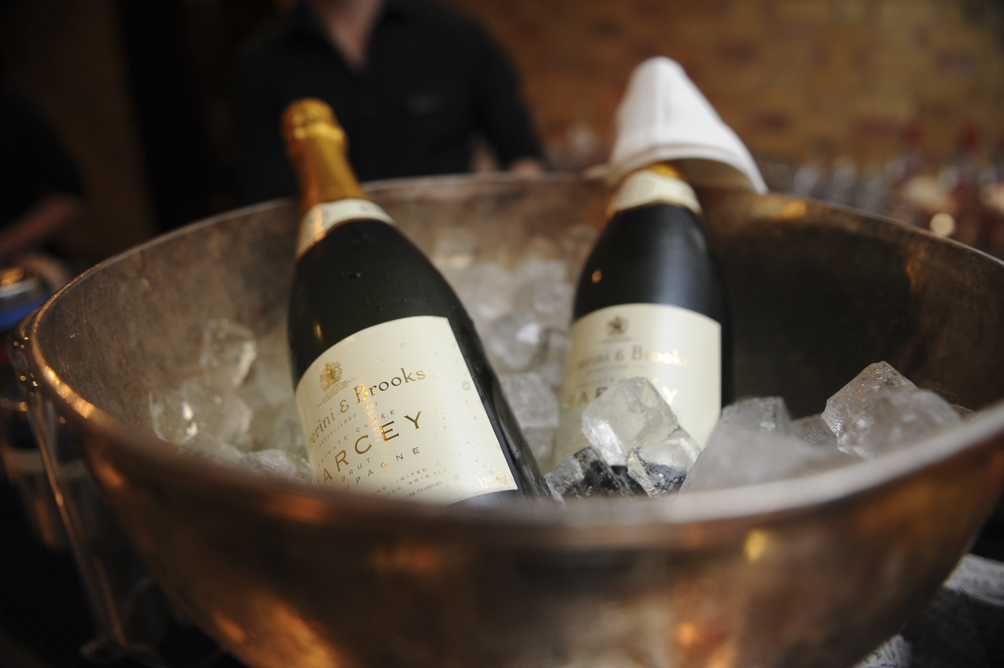 Stylish ice bucket with champagne bottles for upscale event celebration.