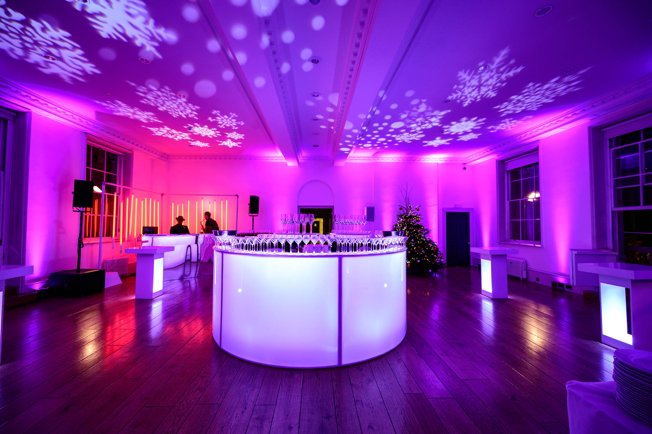 Stylish event space at Somerset House with purple lighting for holiday parties.