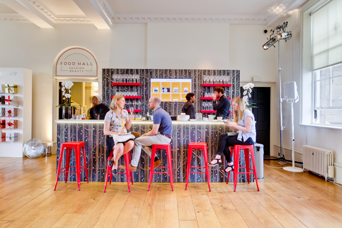 Modern event space at Somerset House with vibrant red stools for networking.
