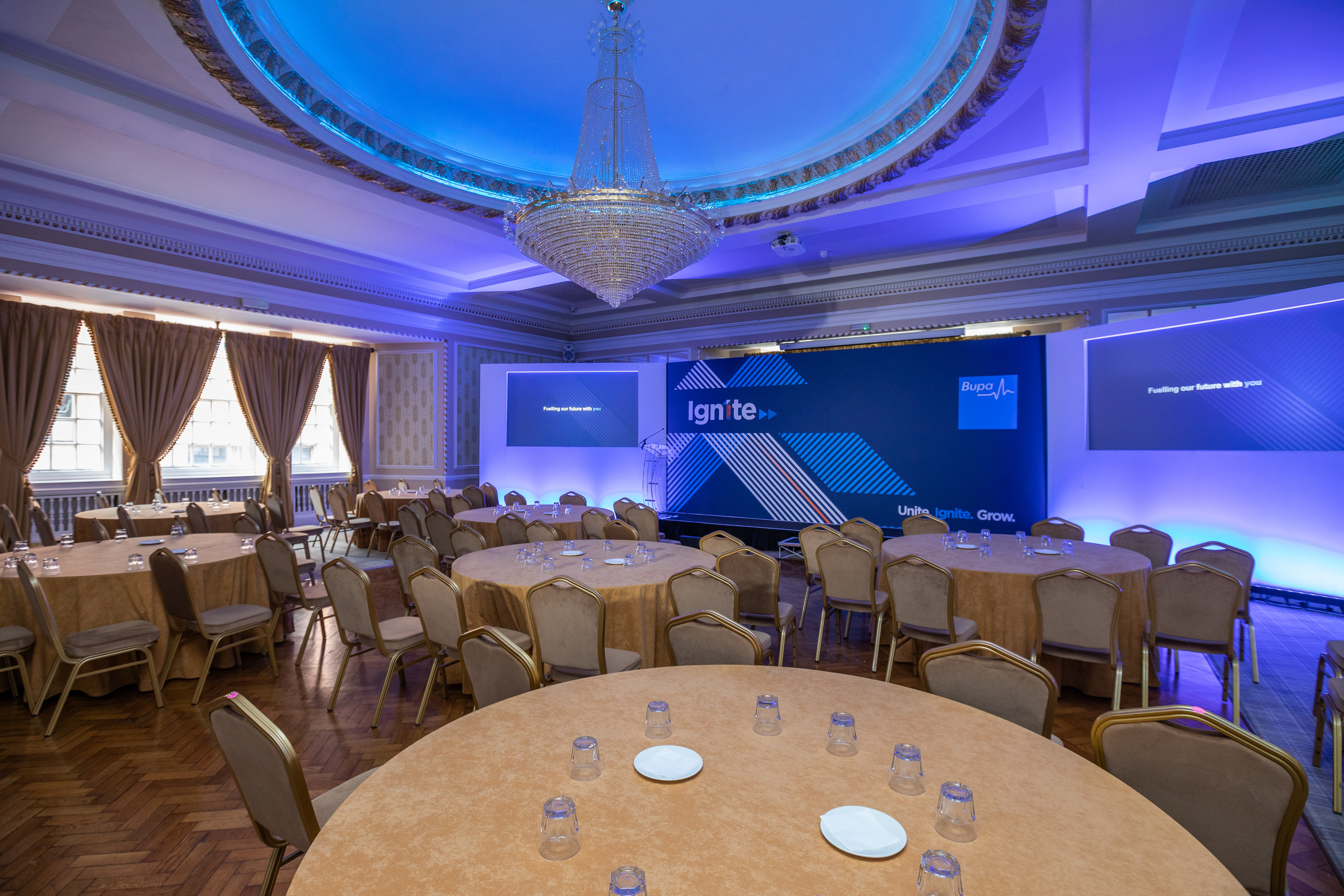 Goulburn Suite event space in Manchester Hall, featuring round tables and elegant drapery.