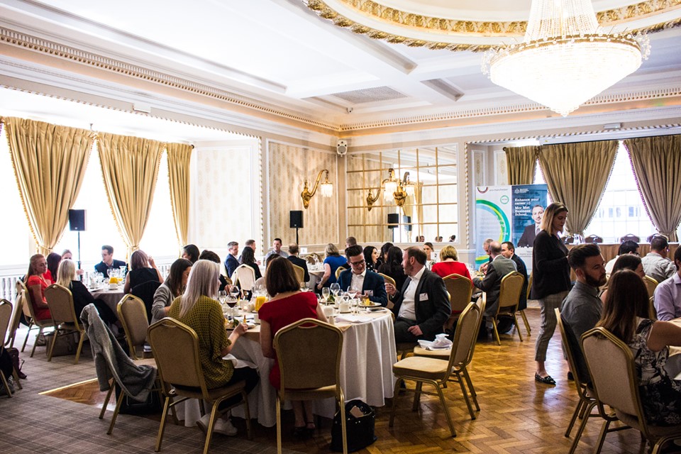 Elegant banquet room in Manchester Hall for networking event with audio-visual setup.