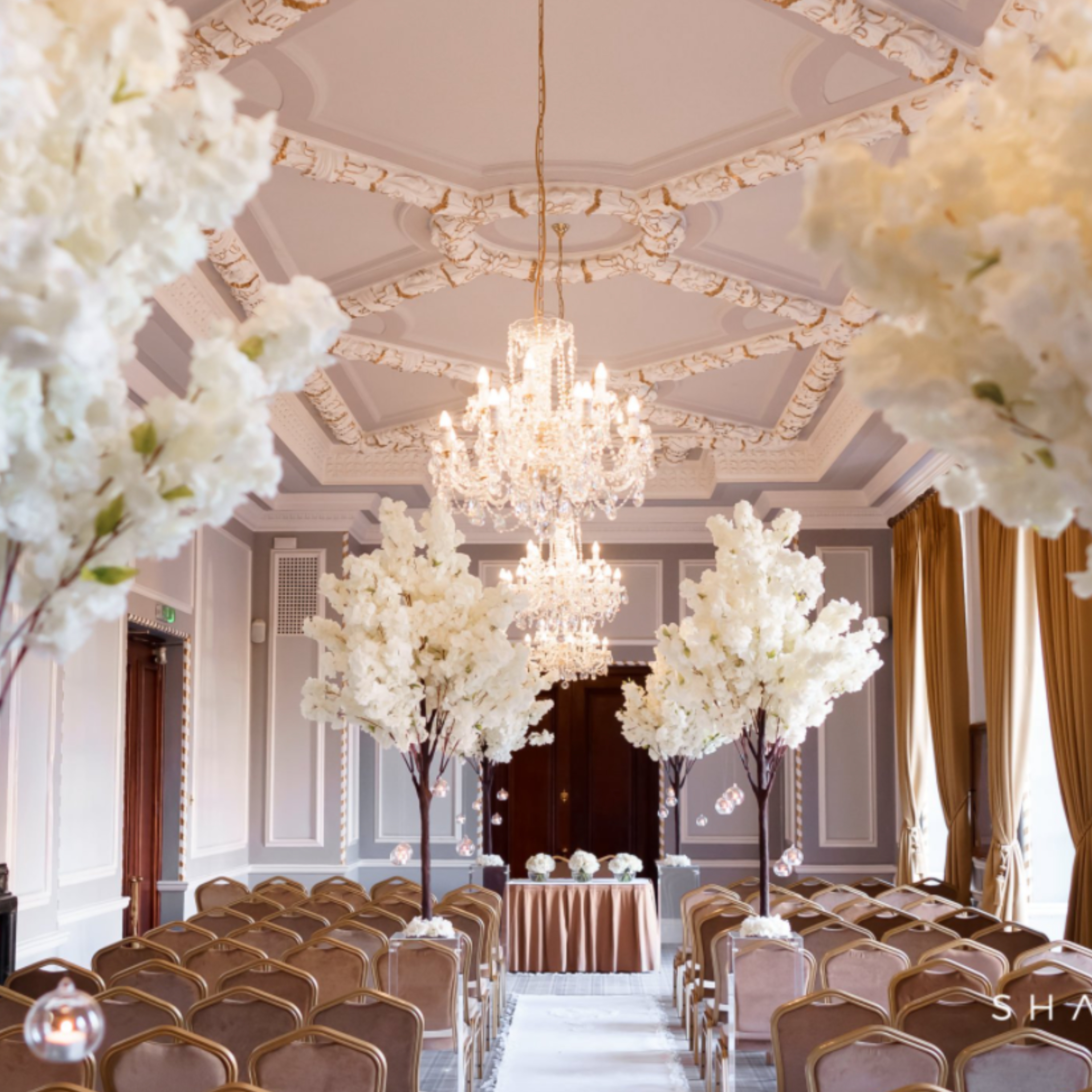 Elegant event space in Manchester Hall with tall floral arrangements for weddings and meetings.