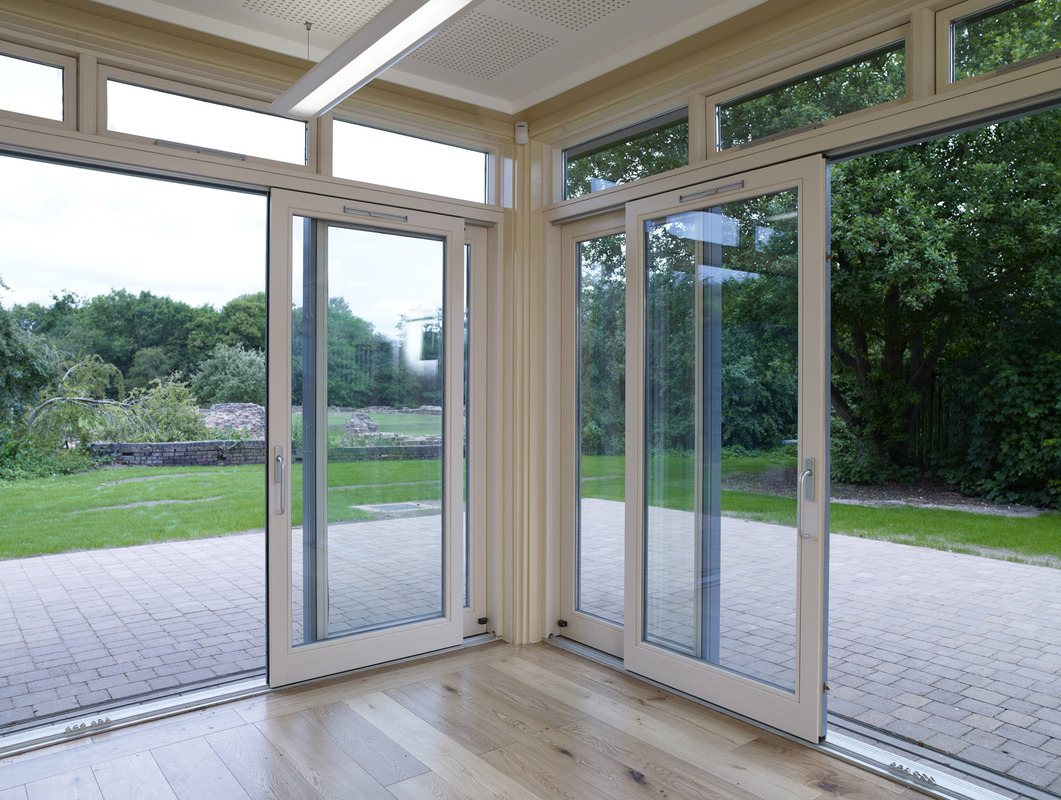 Bright event space in Weoley Castle with large glass doors for outdoor gatherings.