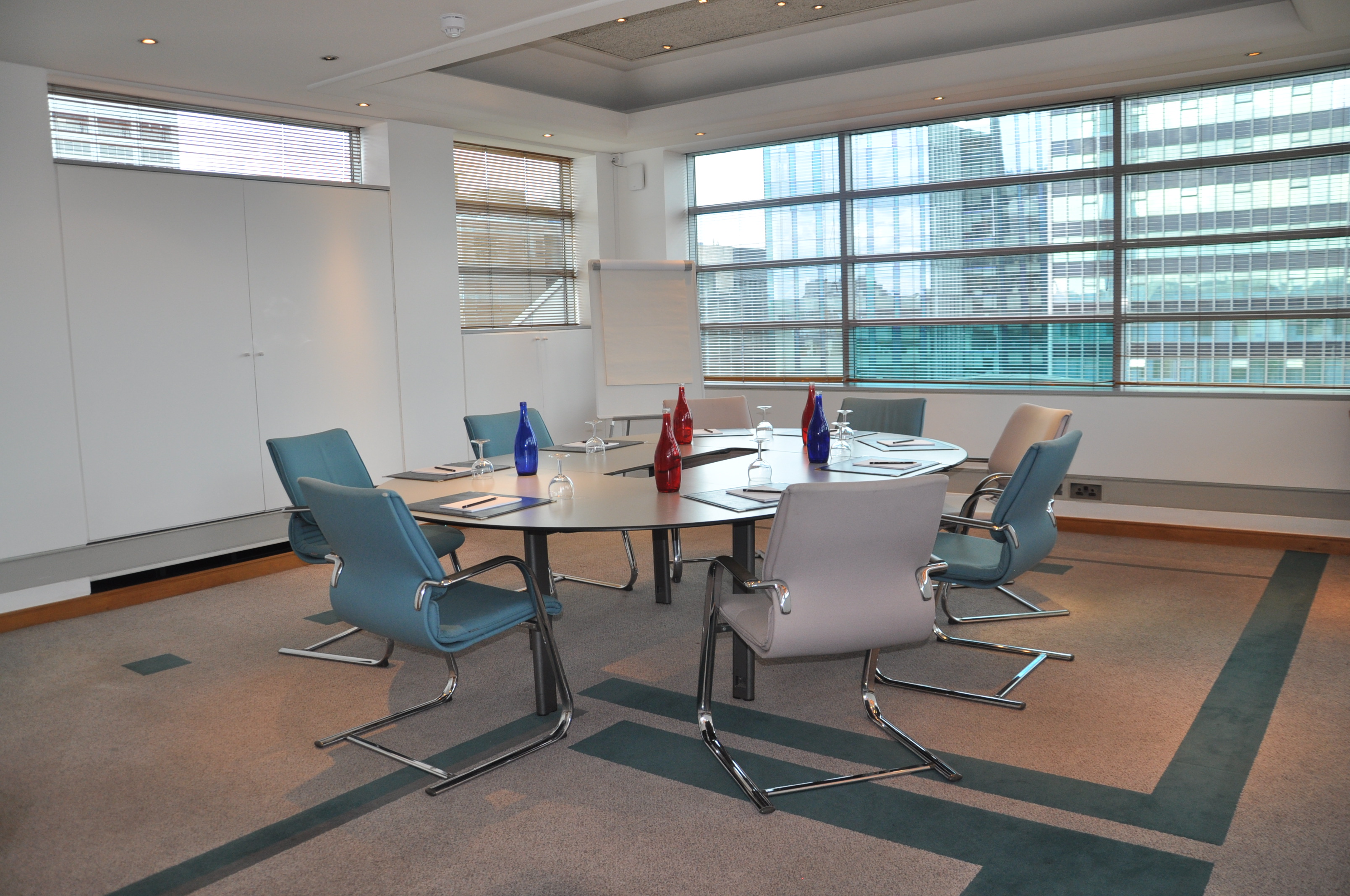 Modern boardroom with round table, ideal for meetings and brainstorming sessions.