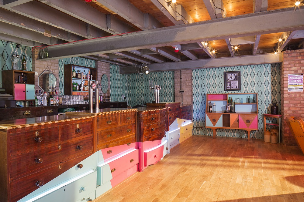 Vibrant event space with stylish bar, ideal for gatherings and workshops at The Night Owl.