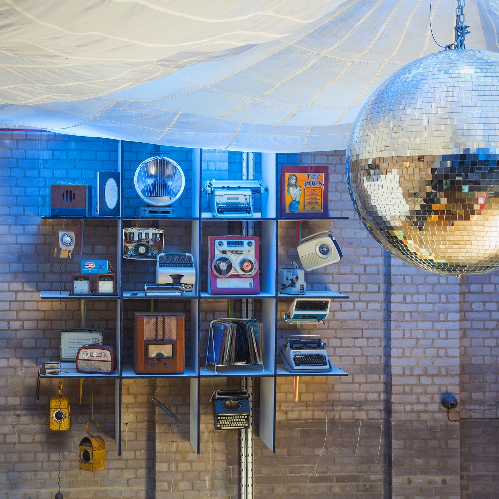 Main room at The Night Owl with vintage radios and disco ball for themed events.