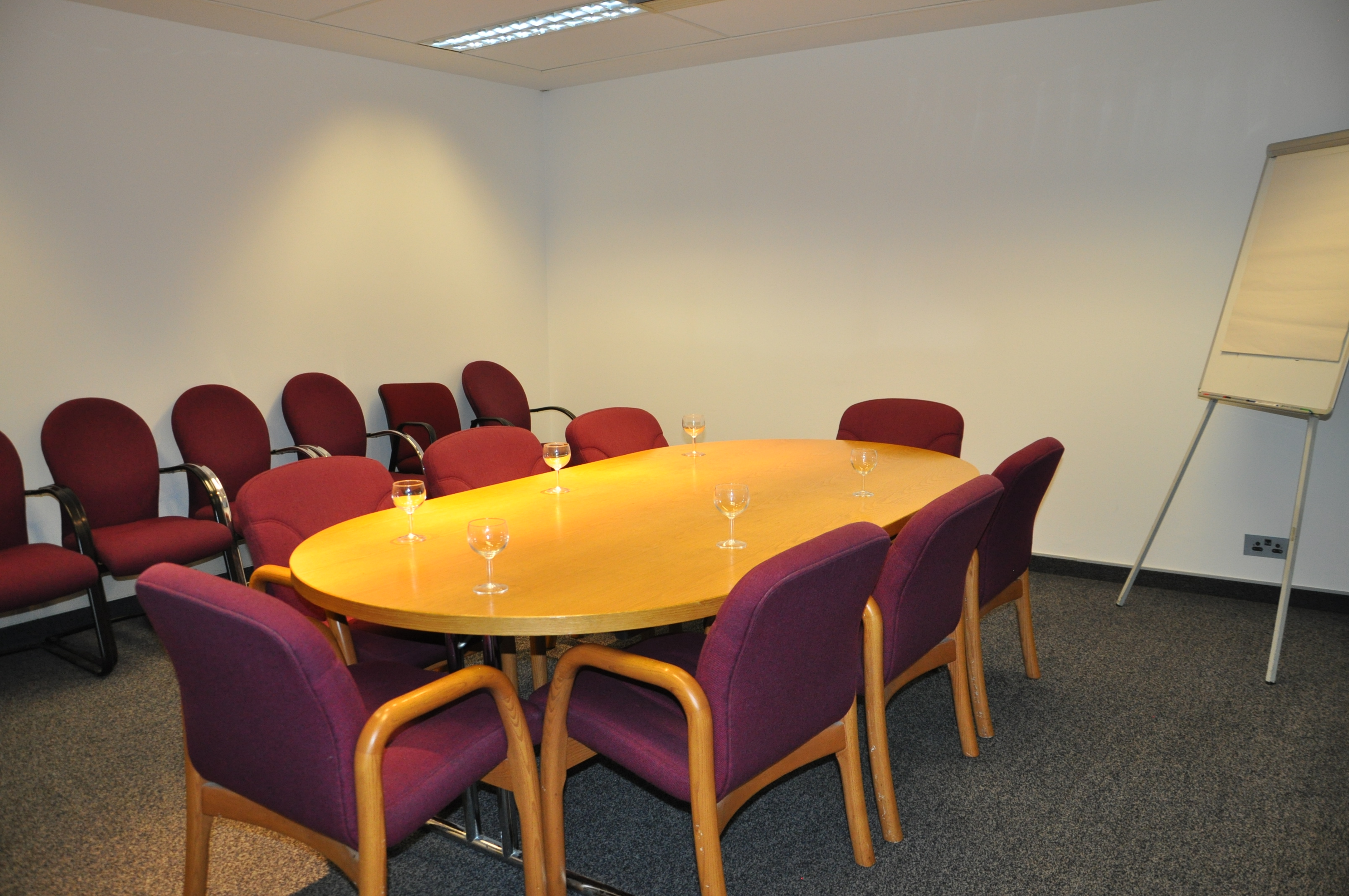 4th Floor Vanadium Room with oval table, ideal for professional meetings and presentations.