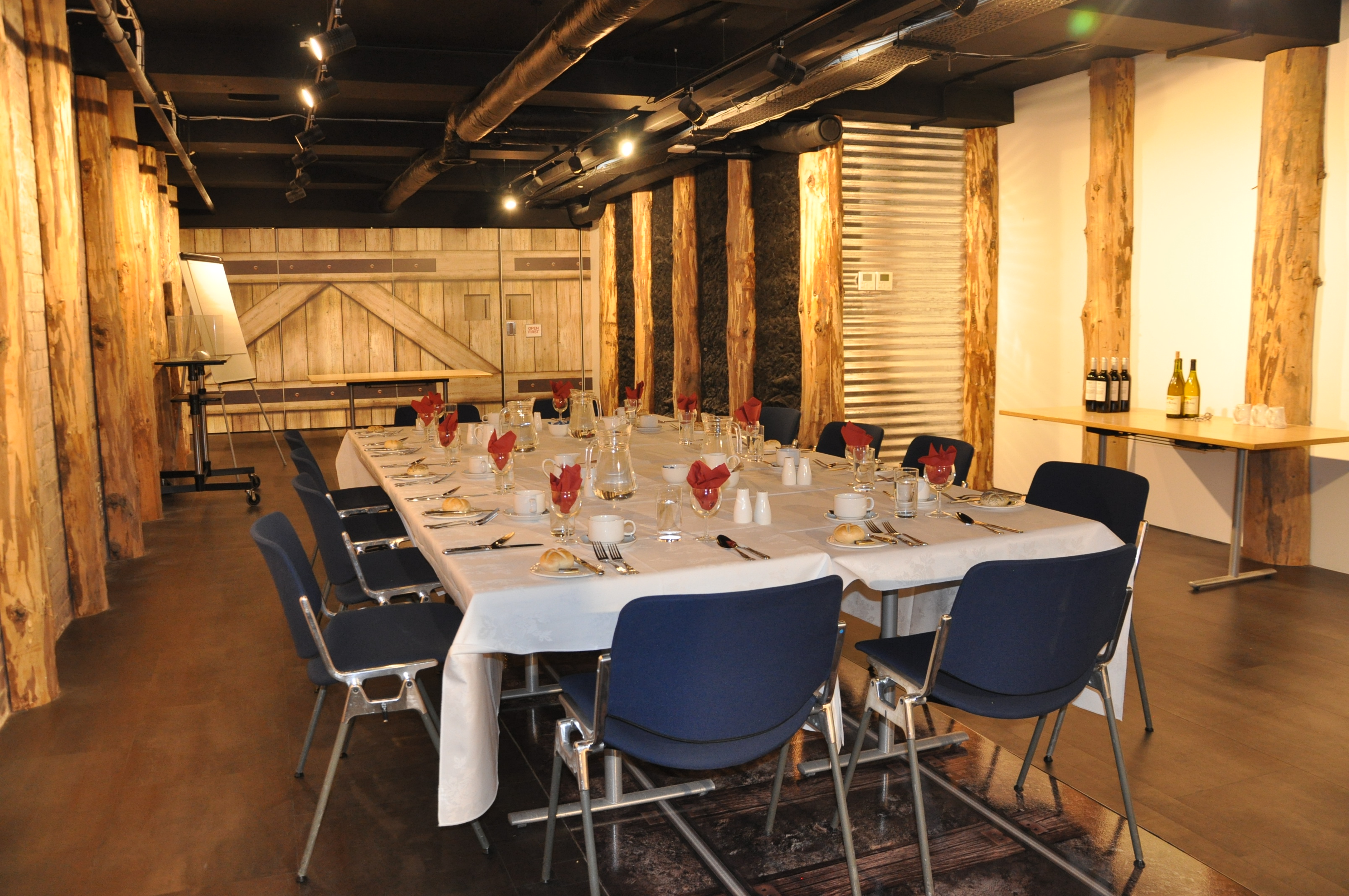 Elegant meeting space with rustic beams, perfect for corporate dinners and workshops.