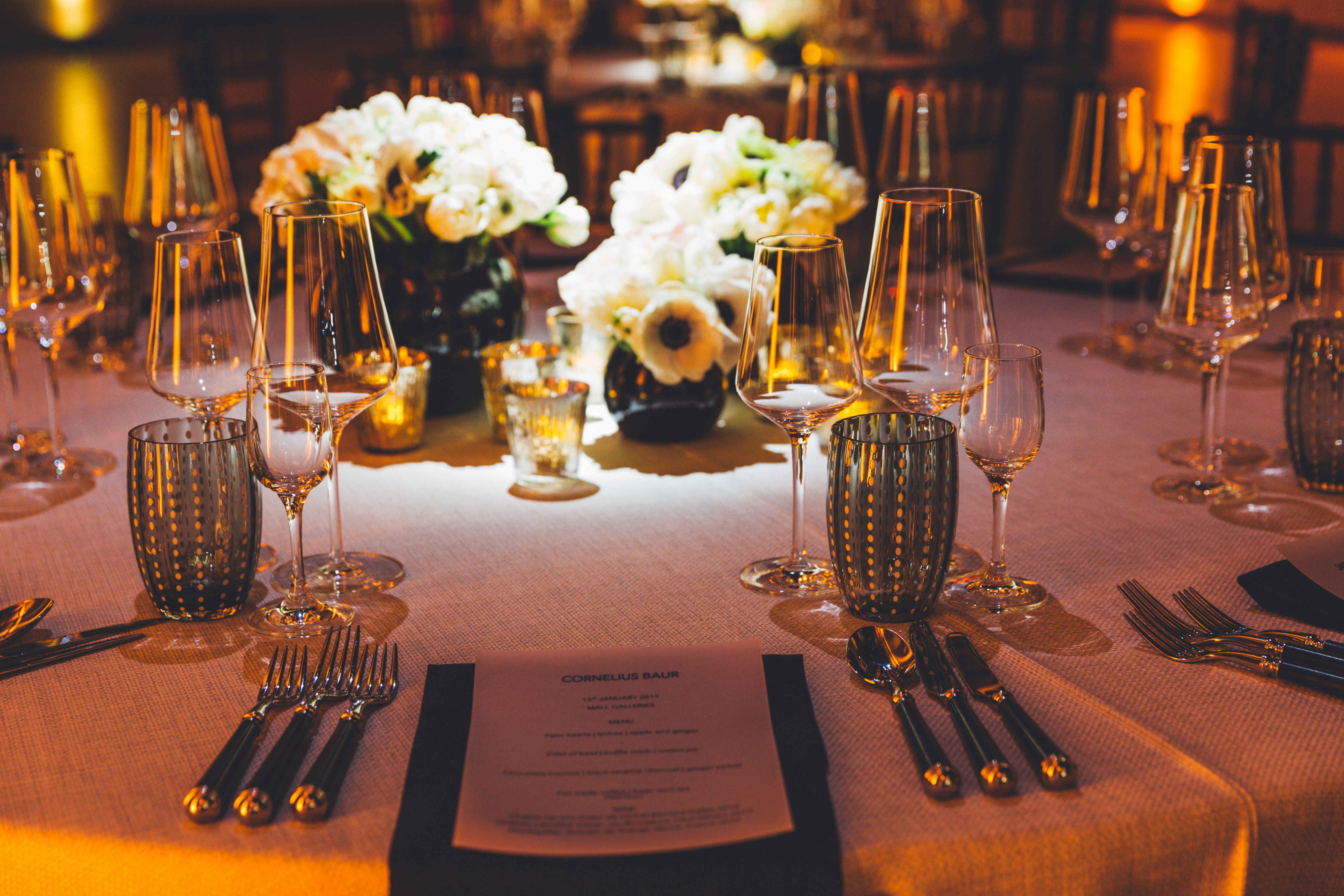 Elegant dining table with floral centerpieces for exclusive hire events at Mall Galleries.
