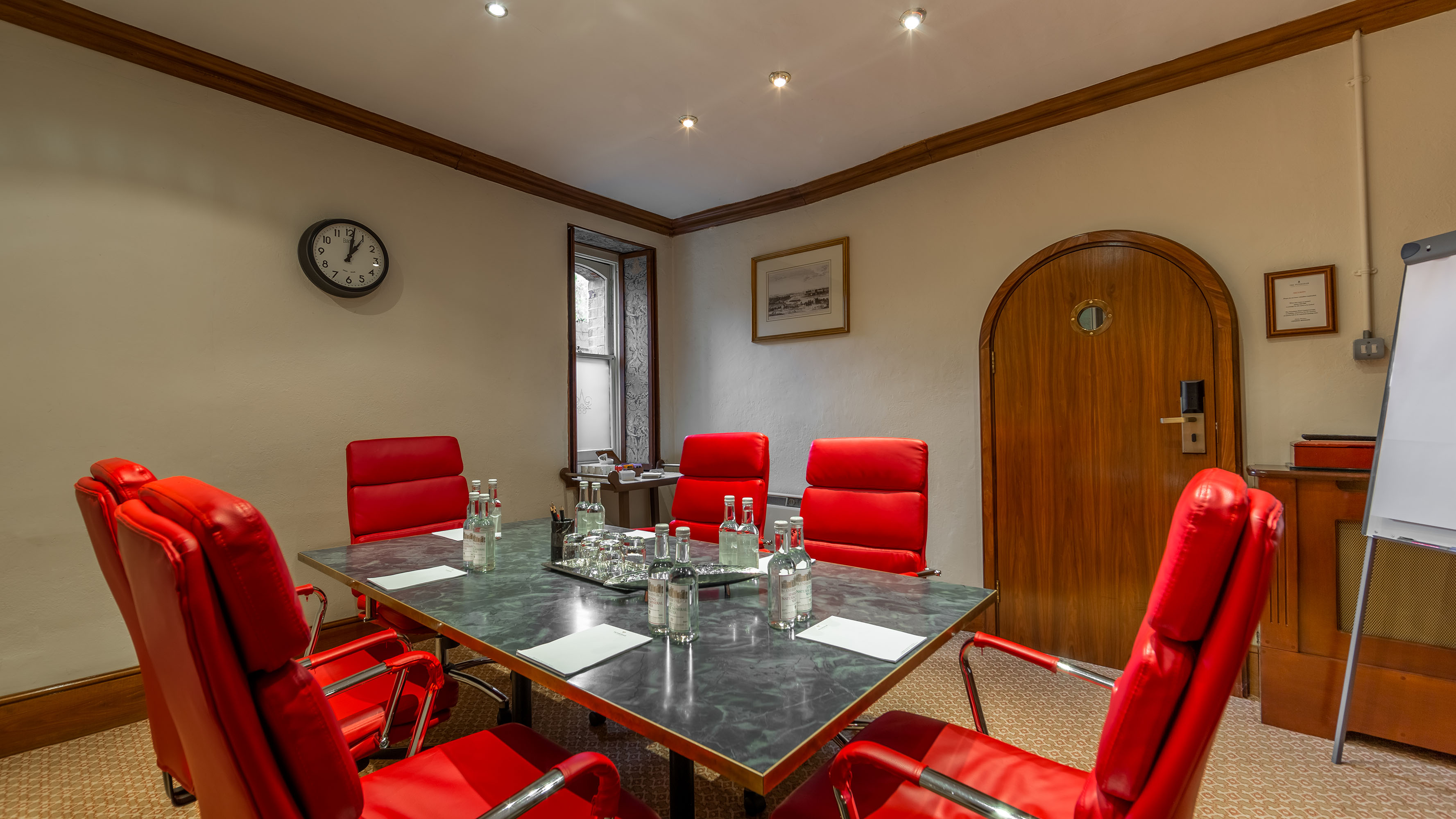Small study at Petersham Hotel with red chairs, ideal for meetings and brainstorming.