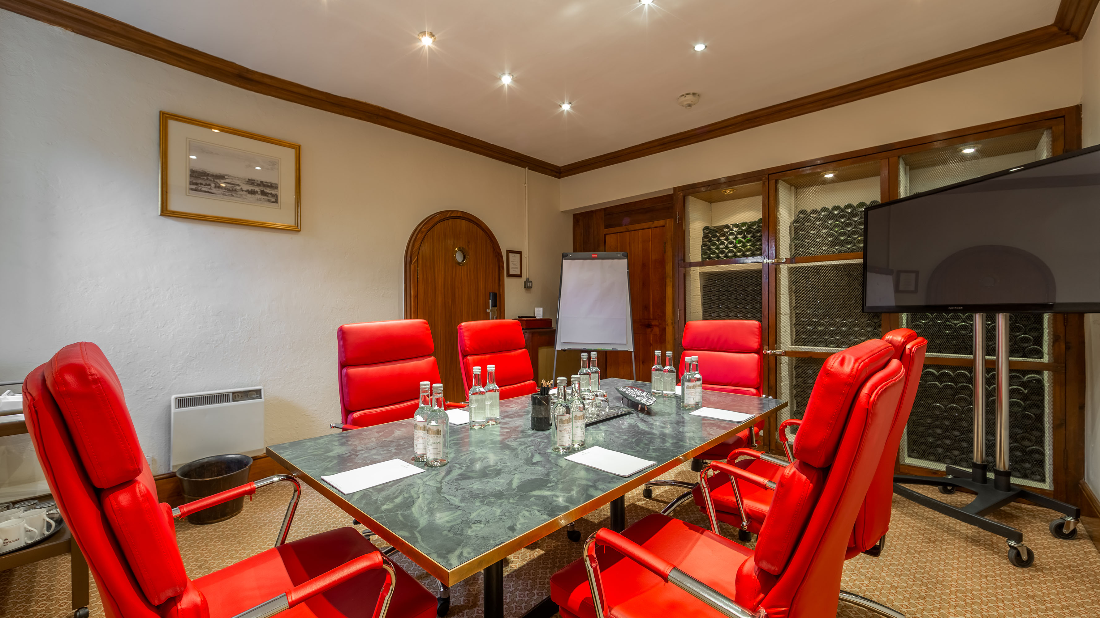 Small Study at Petersham Hotel with modern table and red chairs for meetings and workshops.