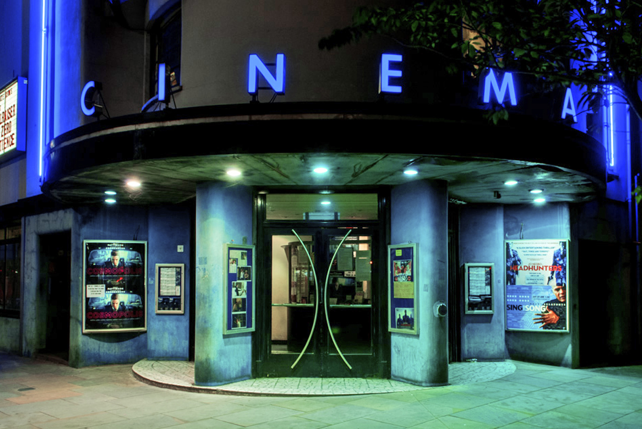 "Modern Rio Cinema auditorium entrance with blue lighting, perfect for film premieres and events."