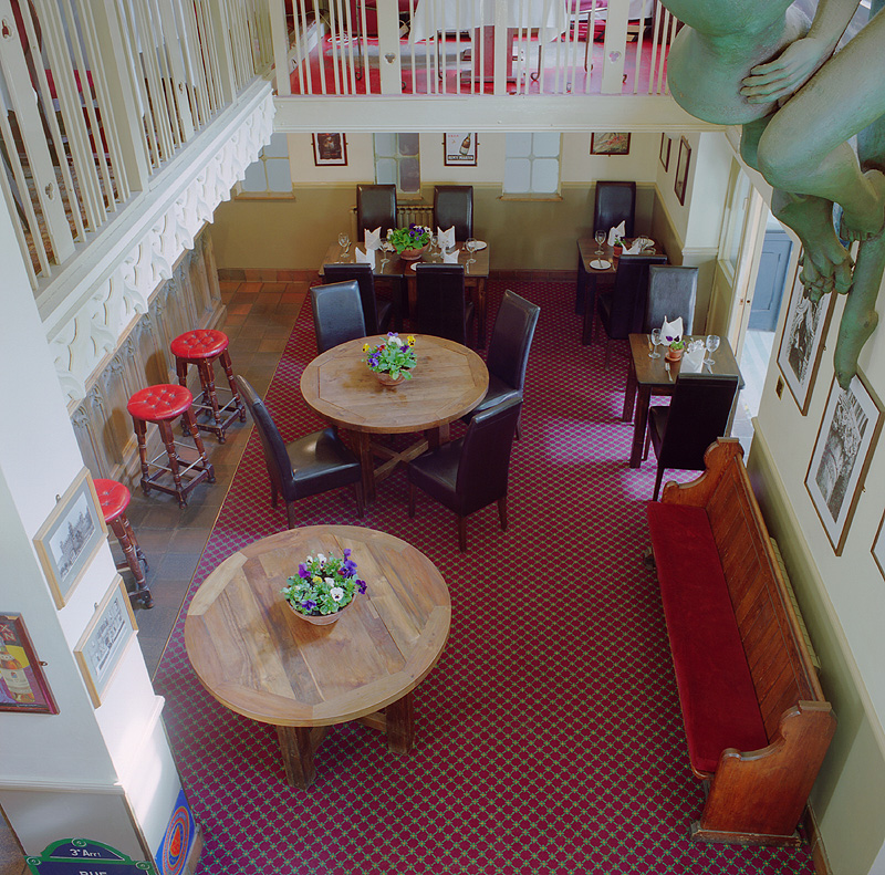 Gothic Bar & Restaurant event space with round tables, ideal for intimate gatherings and receptions.