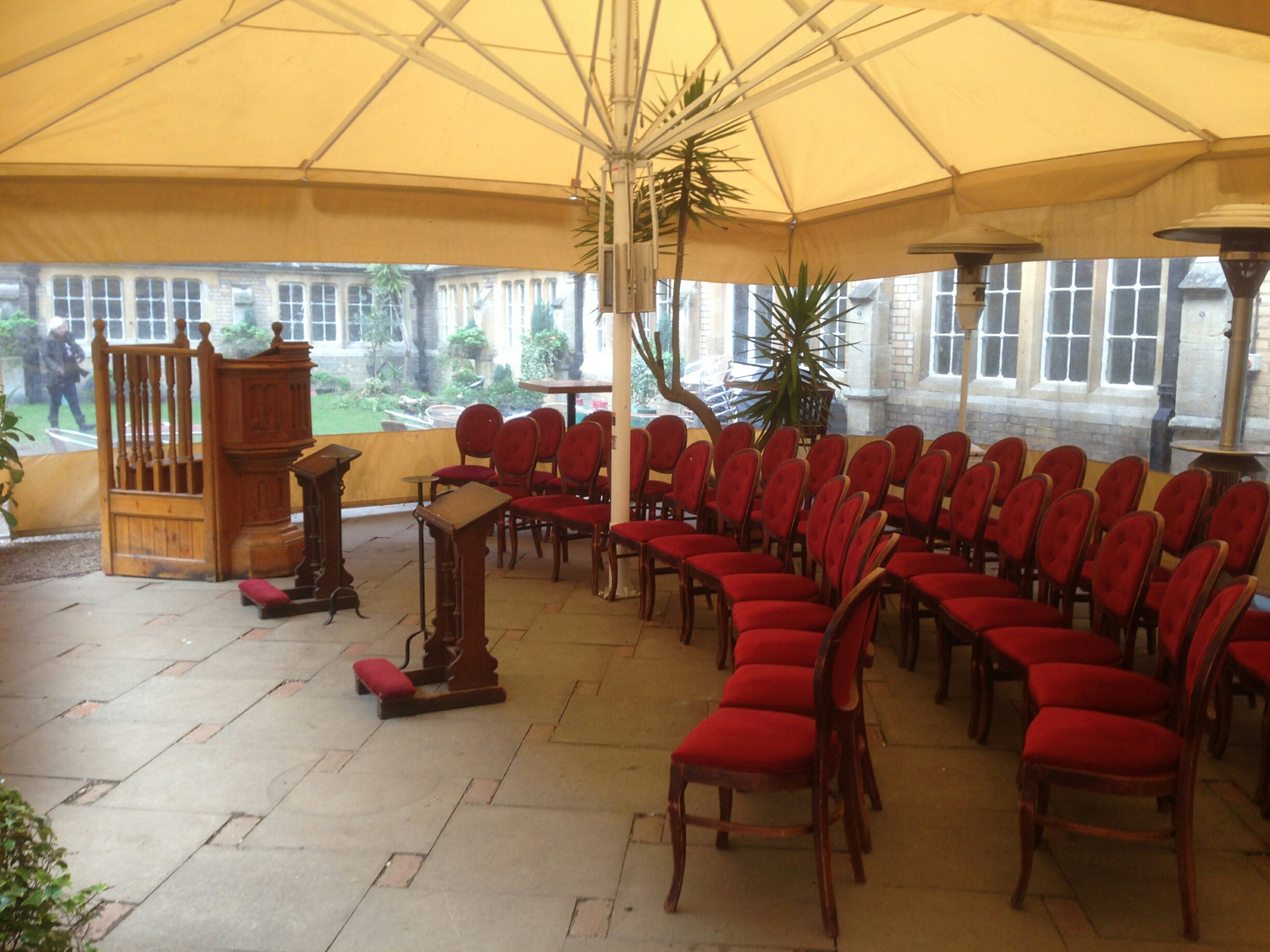 Gothic Bar outdoor event space with red chairs, ideal for weddings and workshops.