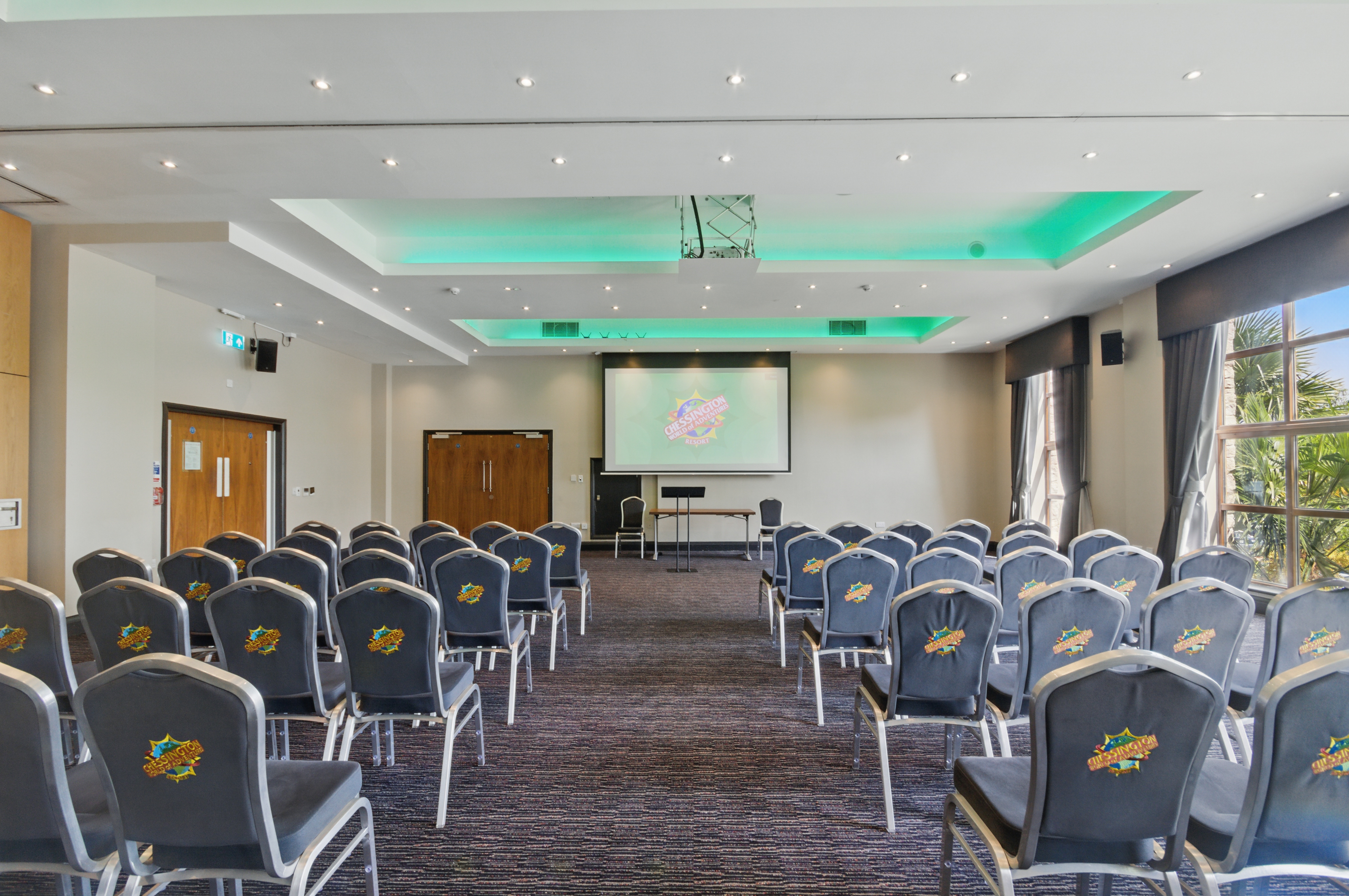 Serengeti Suite meeting room with chairs and screen, perfect for conferences and workshops.