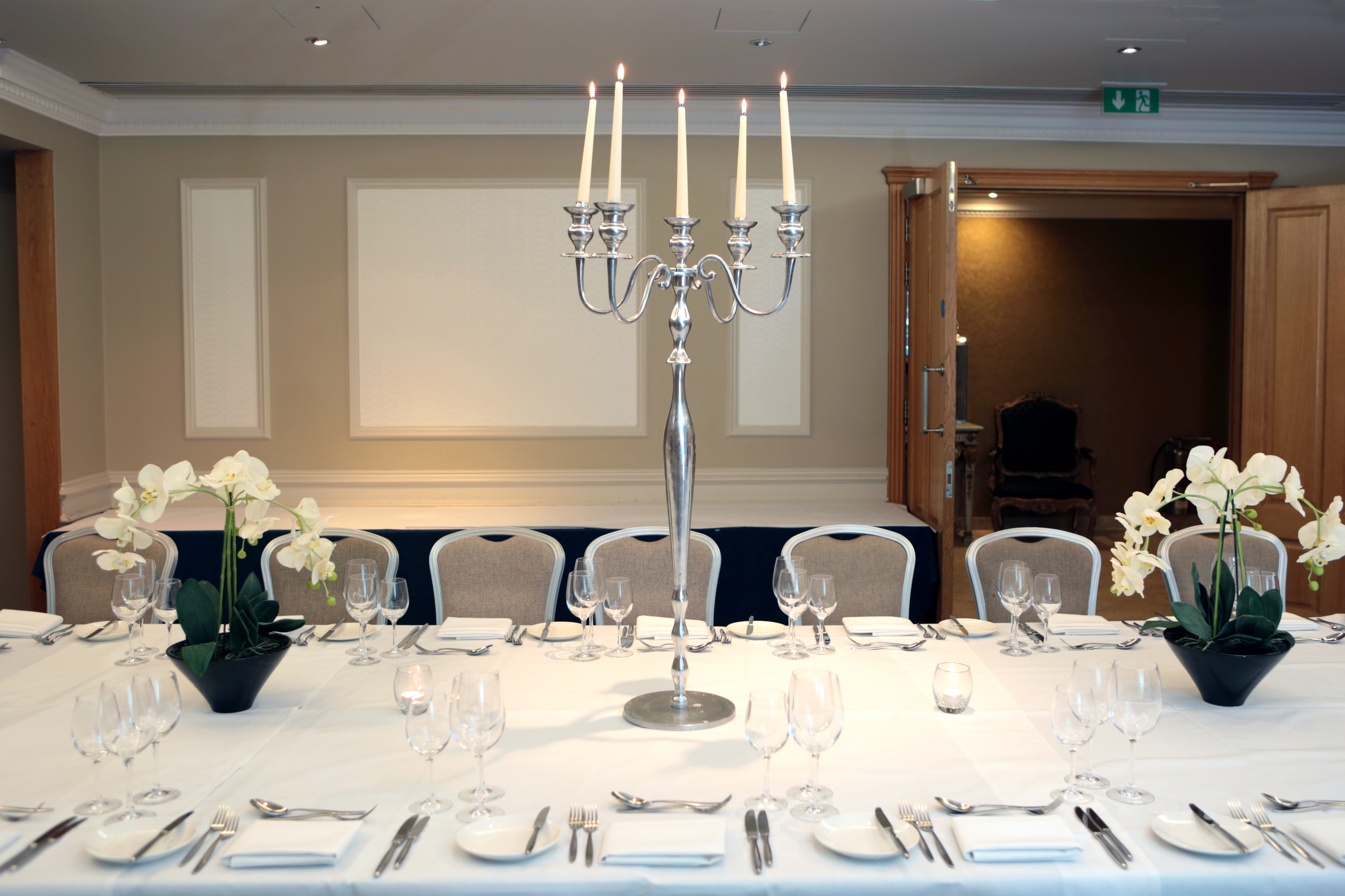 Elegant dining table with candelabra at Wakehurst Suite, ideal for corporate events.
