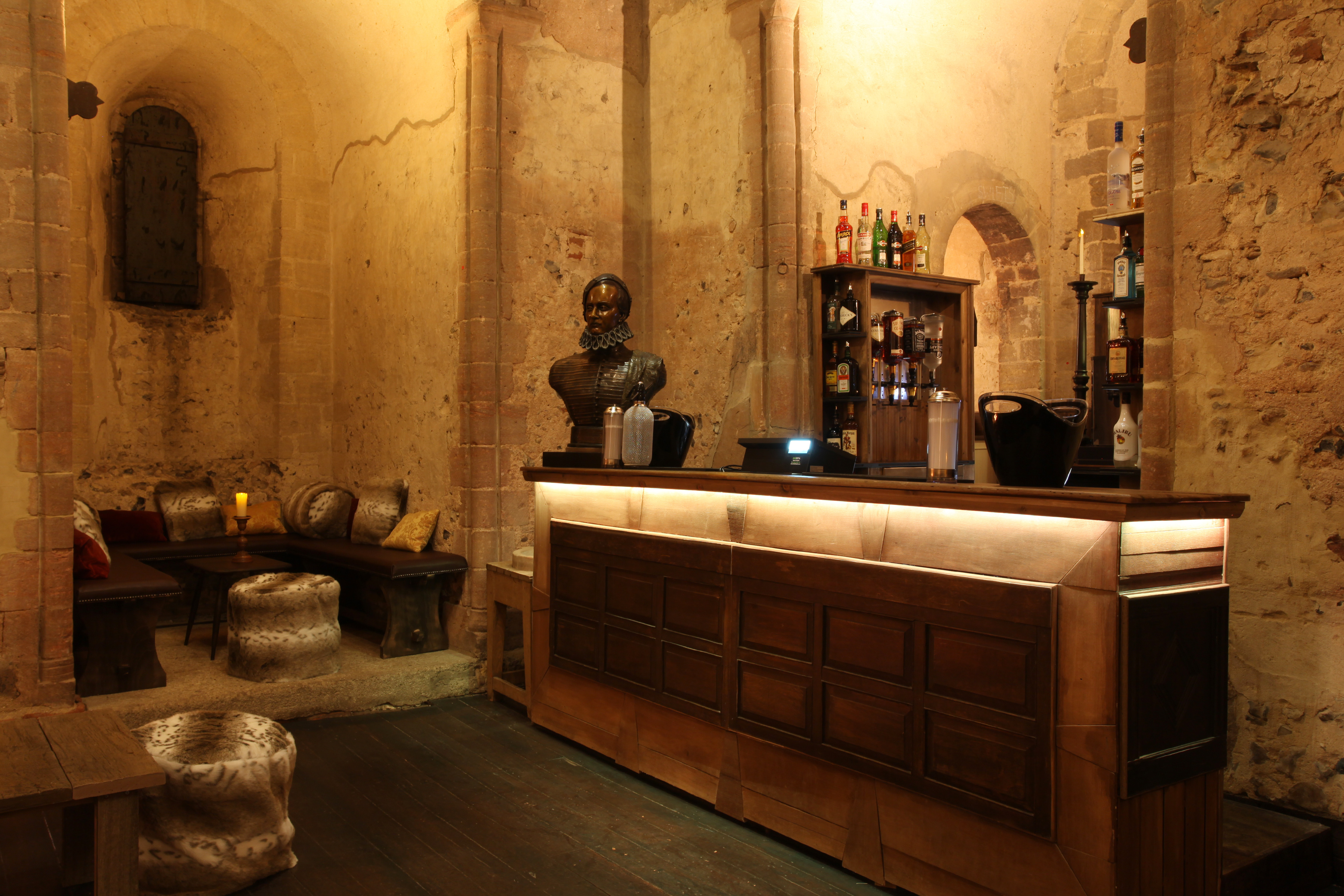 Hedingham Castle event space with rustic bar, ideal for cocktail receptions and gatherings.