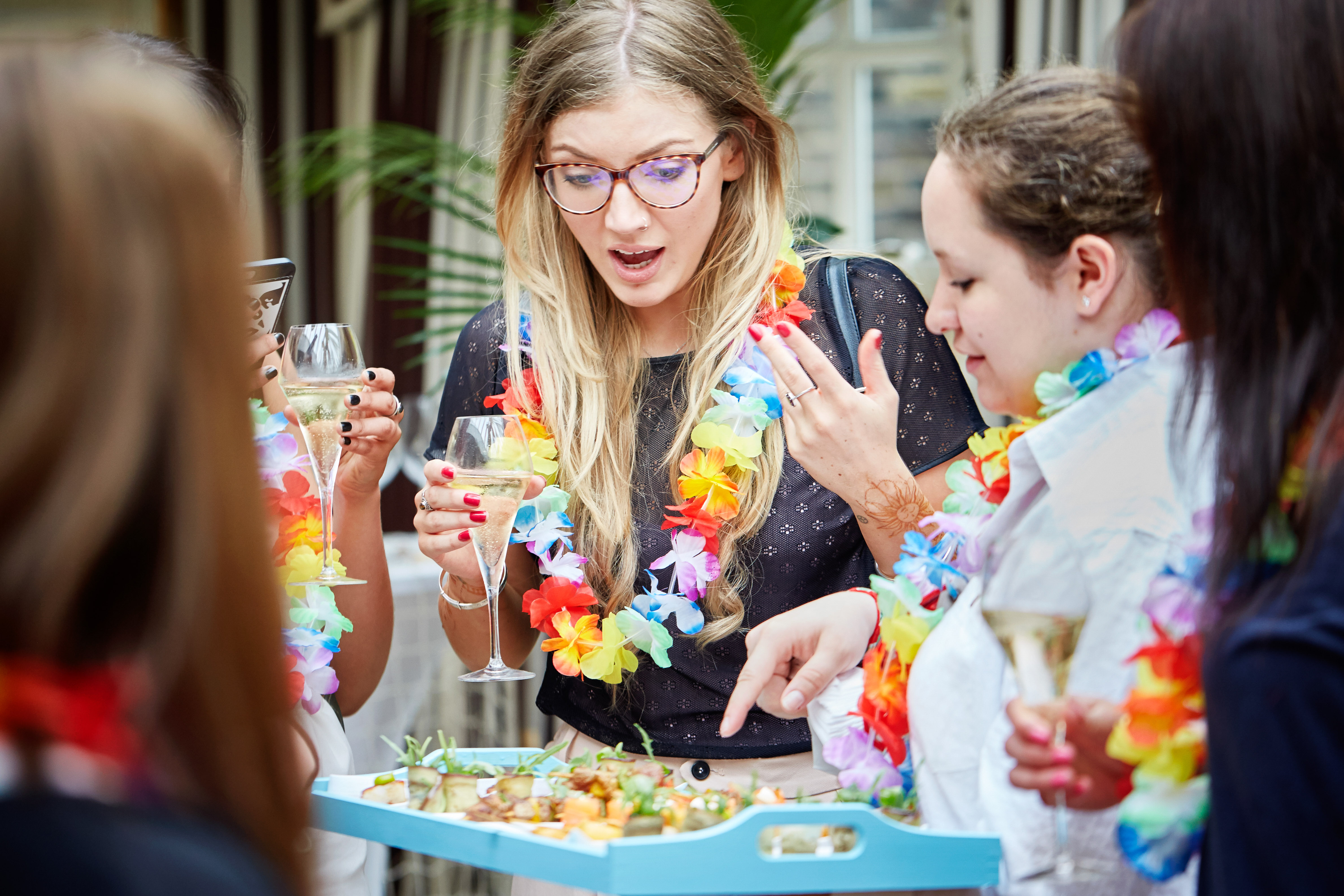 Vibrant networking event at The Beach Bar with colorful leis and festive atmosphere.